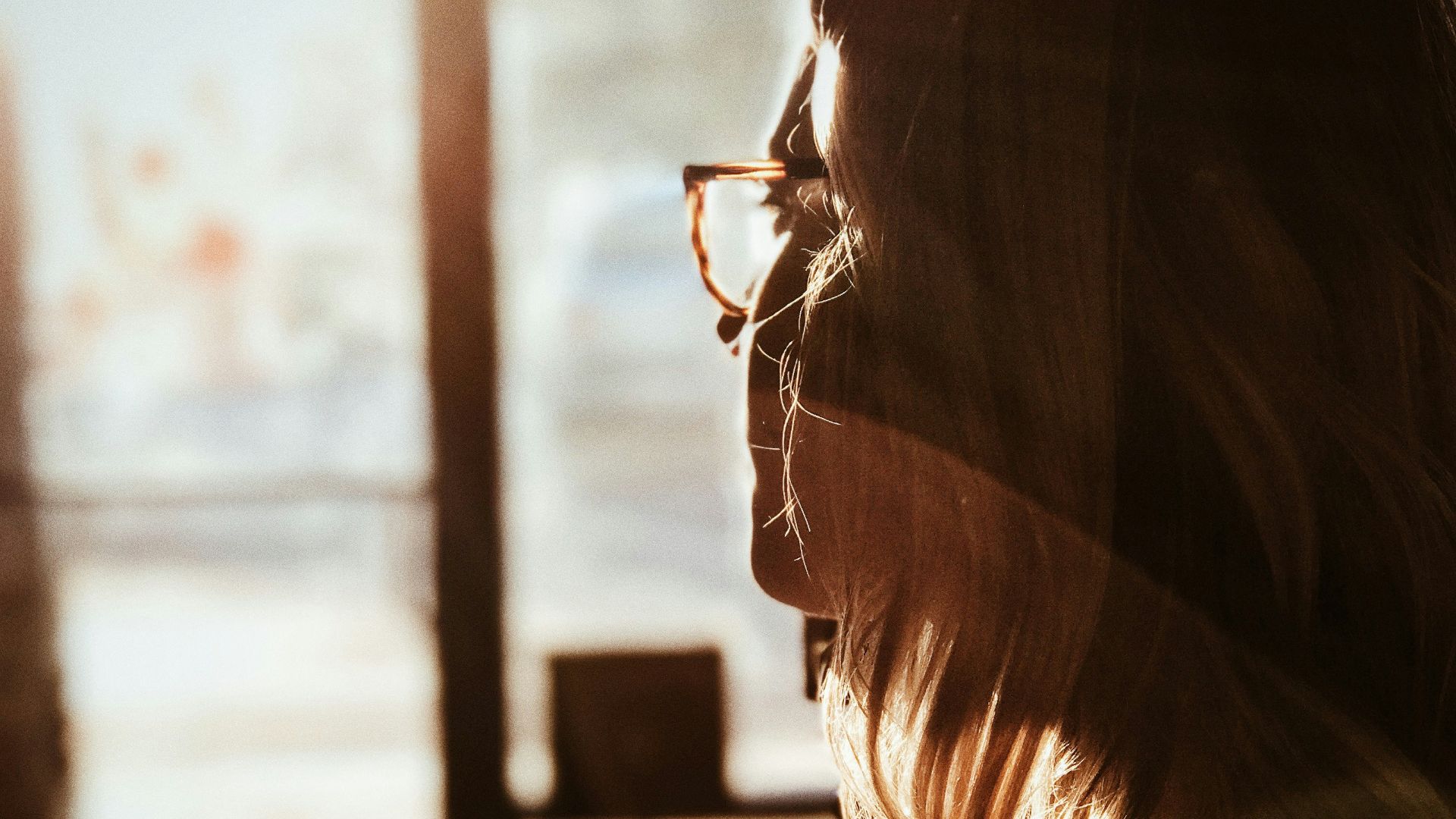 shallow focus photography of woman facing door