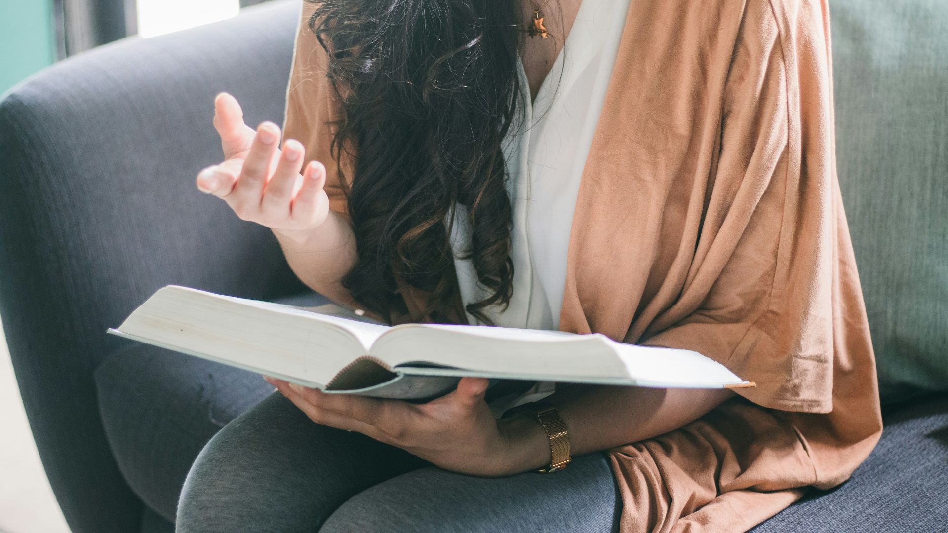 woman in orange blazer sitting on car seat