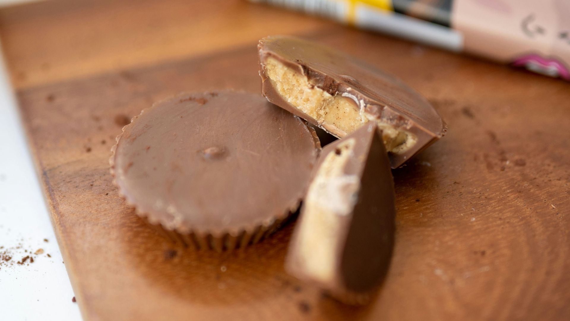 a wooden cutting board topped with a piece of chocolate