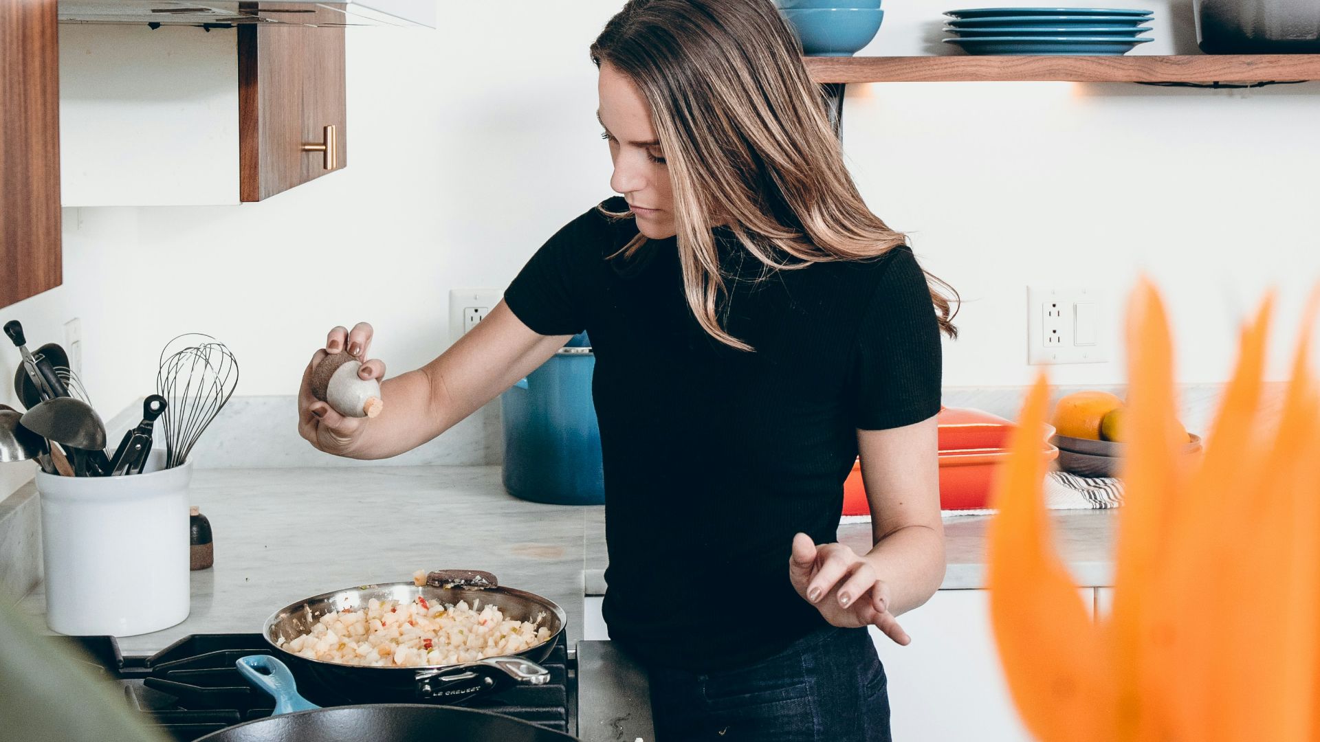 woman standing in front of freestanding range oven