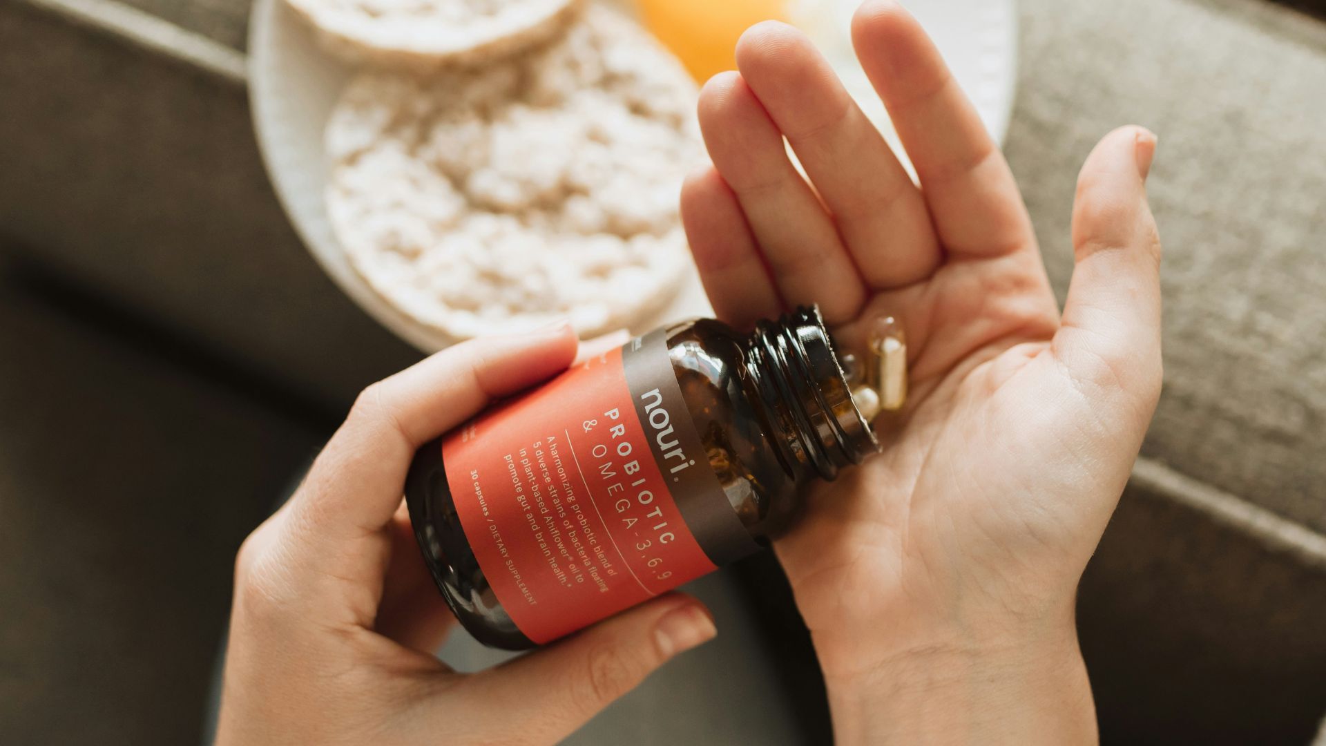 person holding red bottle