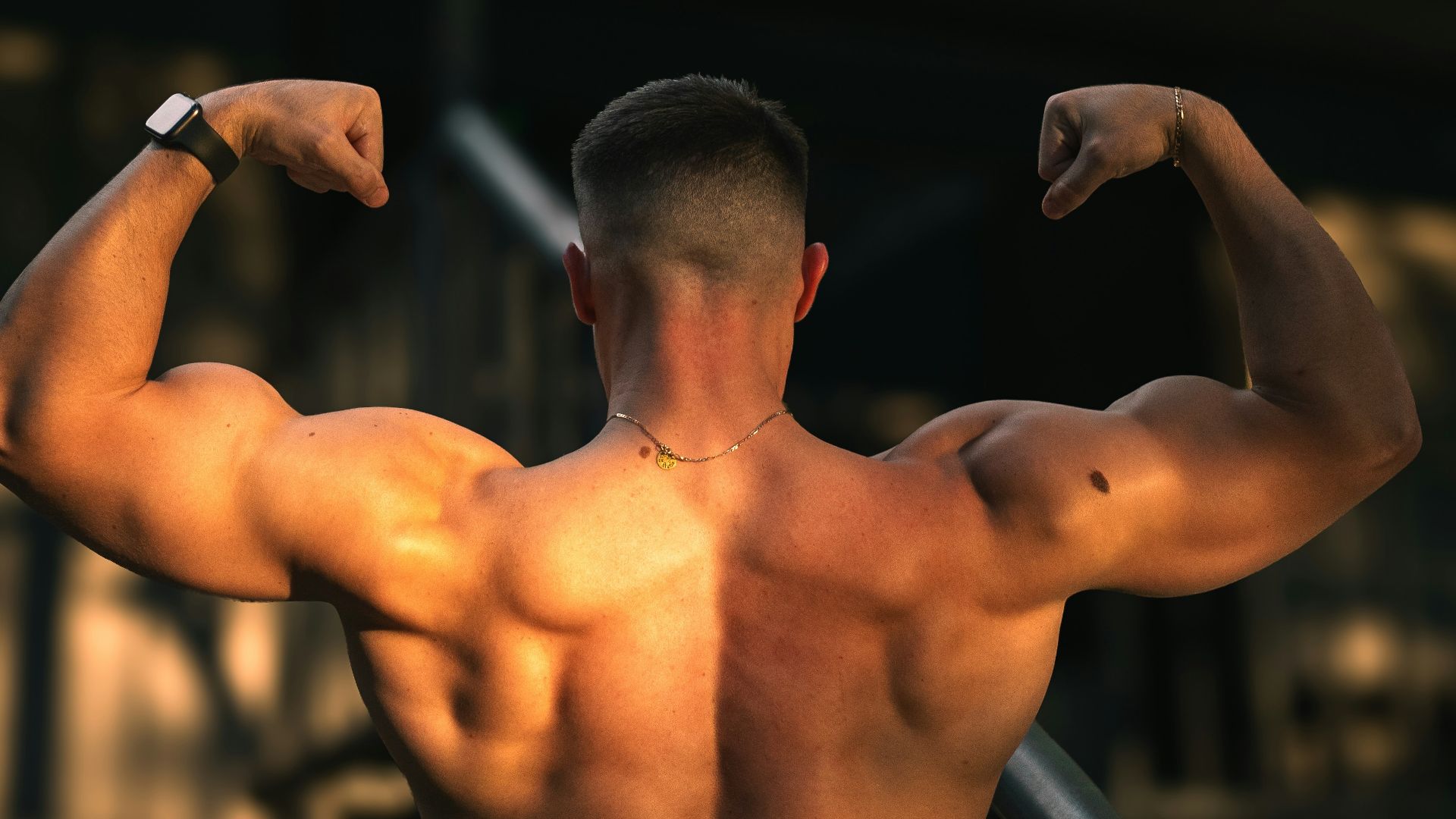a man flexing his muscles on a balcony