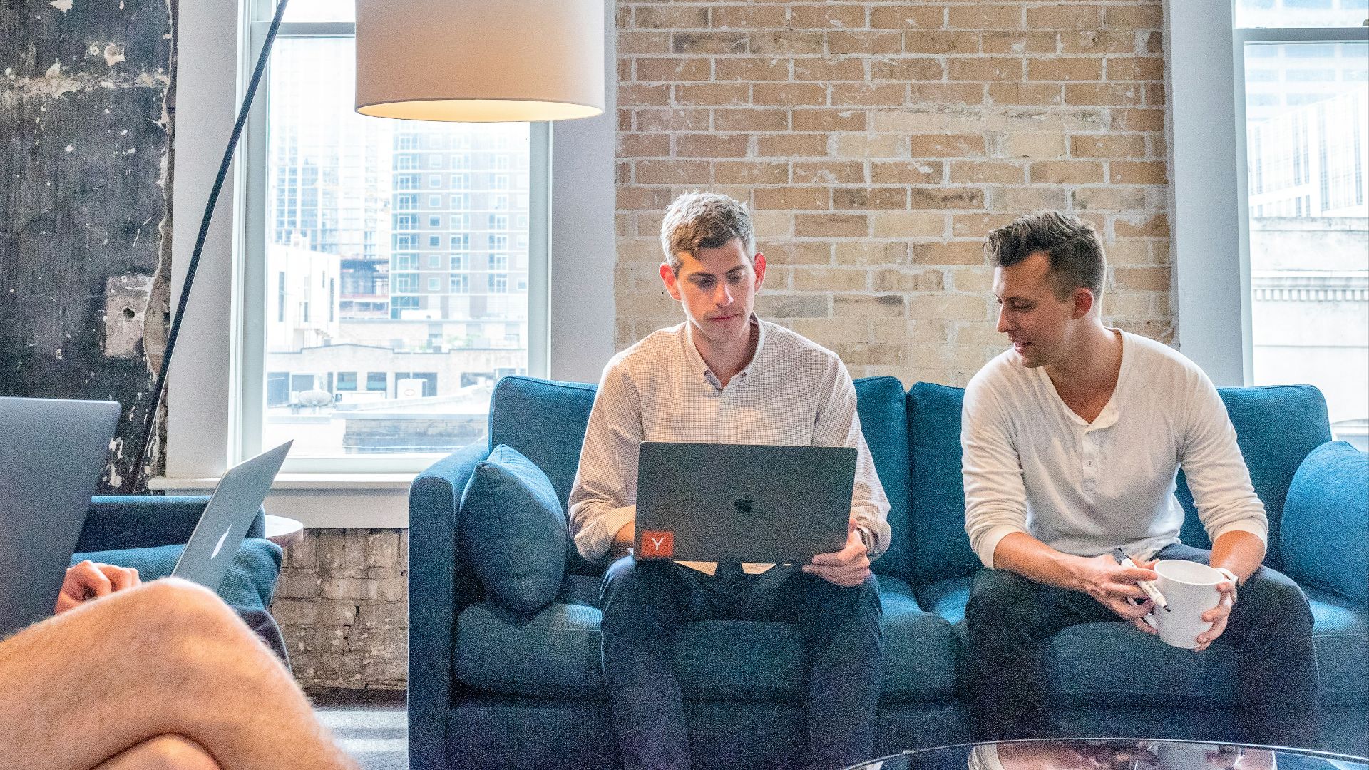 three men using MacBooks