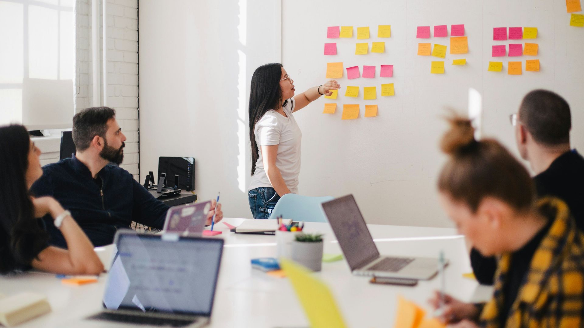 woman placing sticky notes on wall