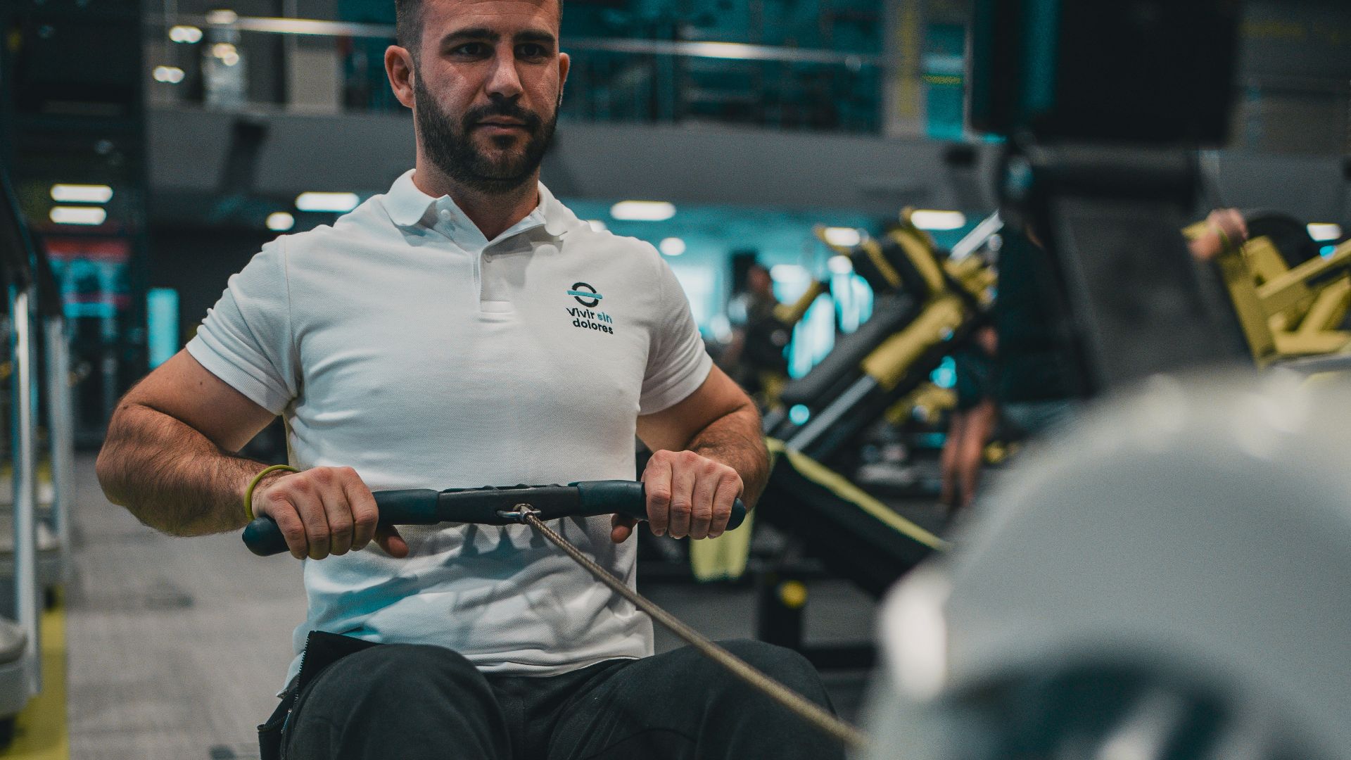A man riding a machine in a gym