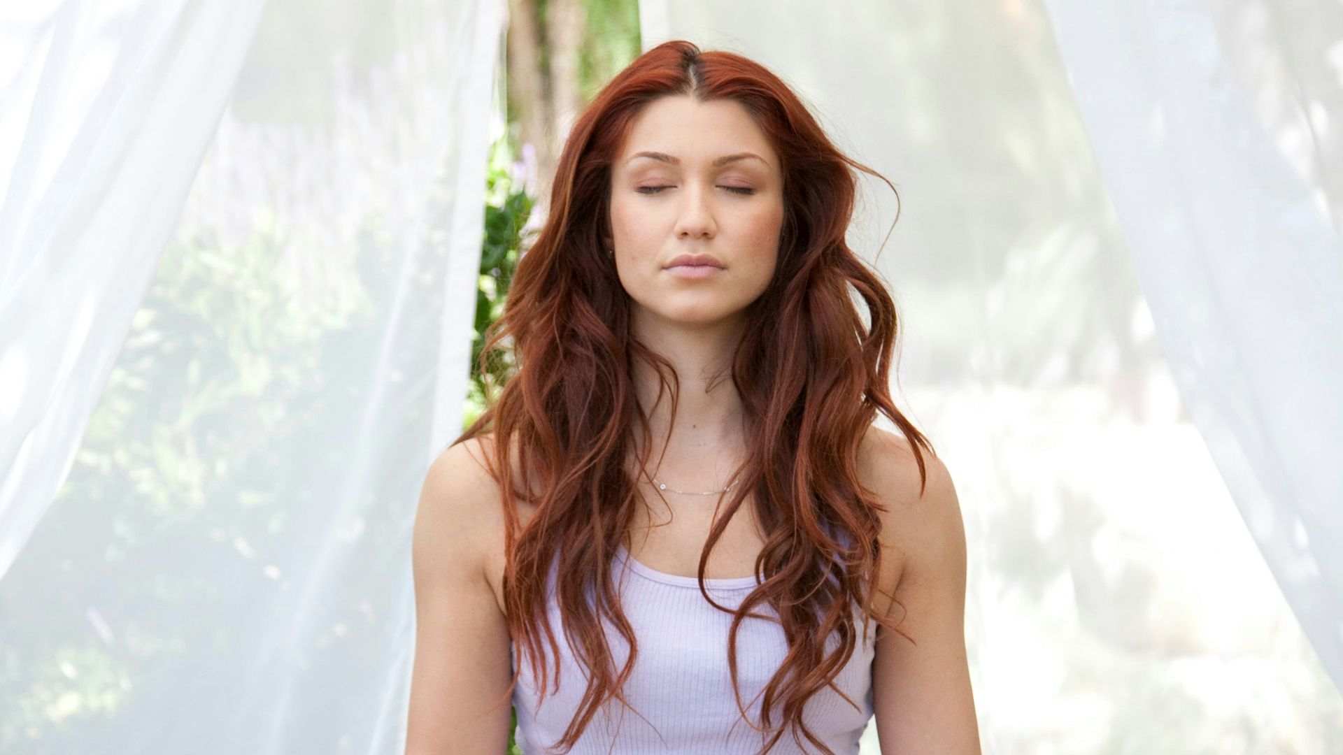 woman doing yoga pose sitting on wooden ground