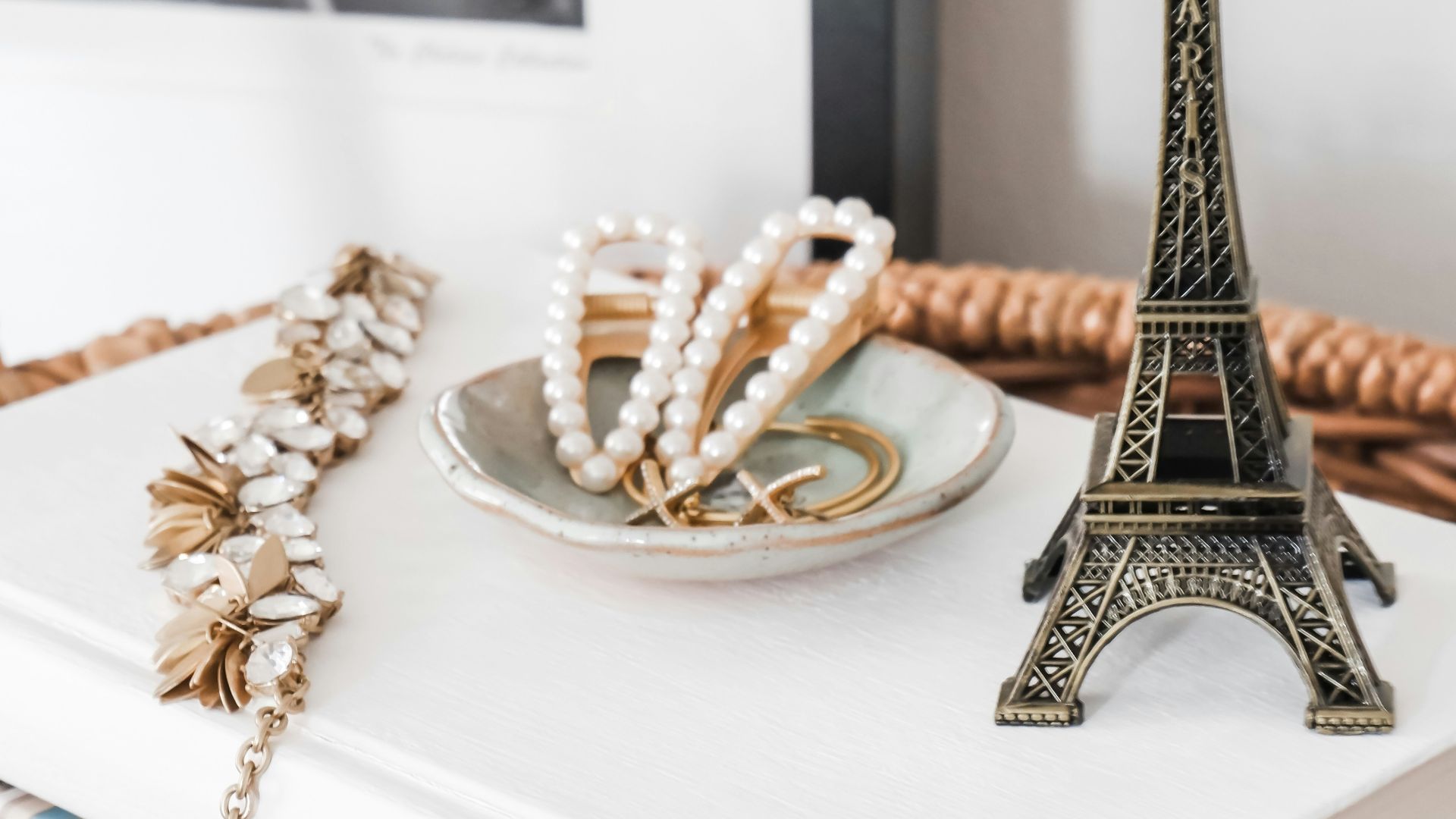 gold eiffel tower miniature on white table