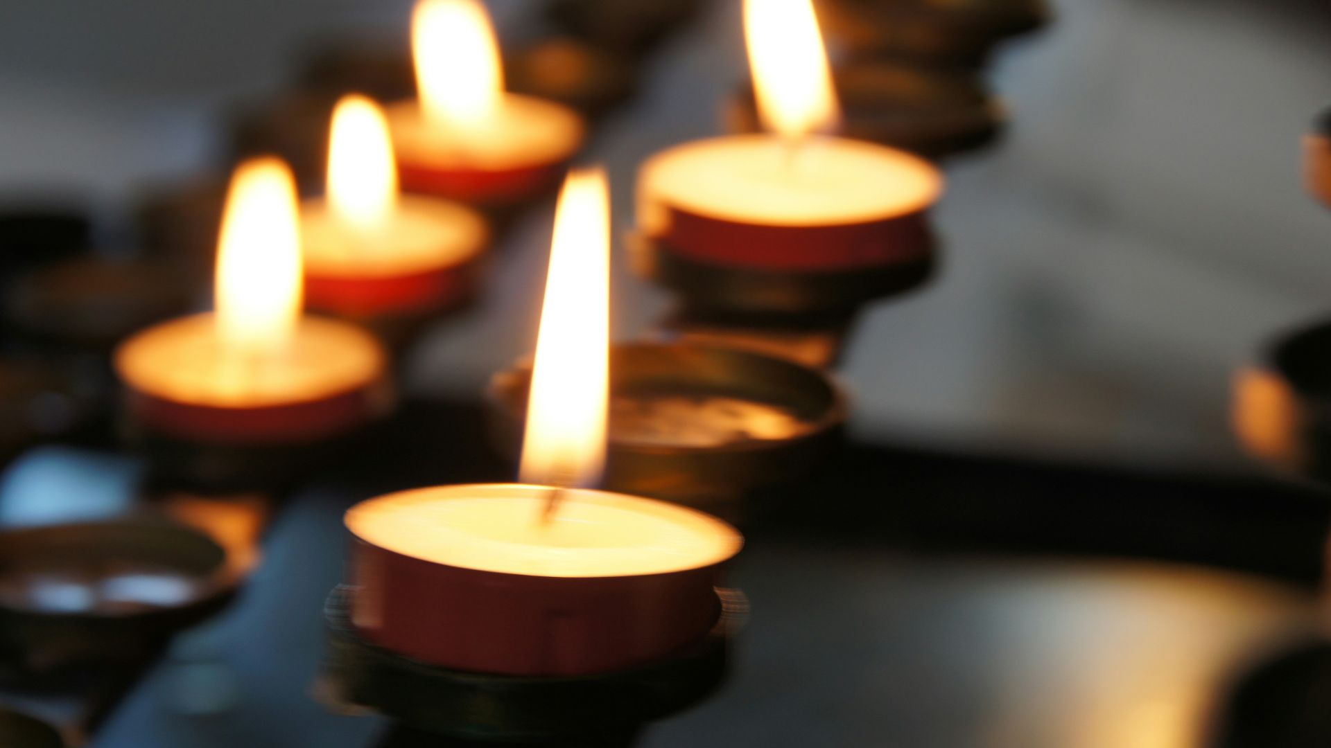 lighted candles on black metal candle holder