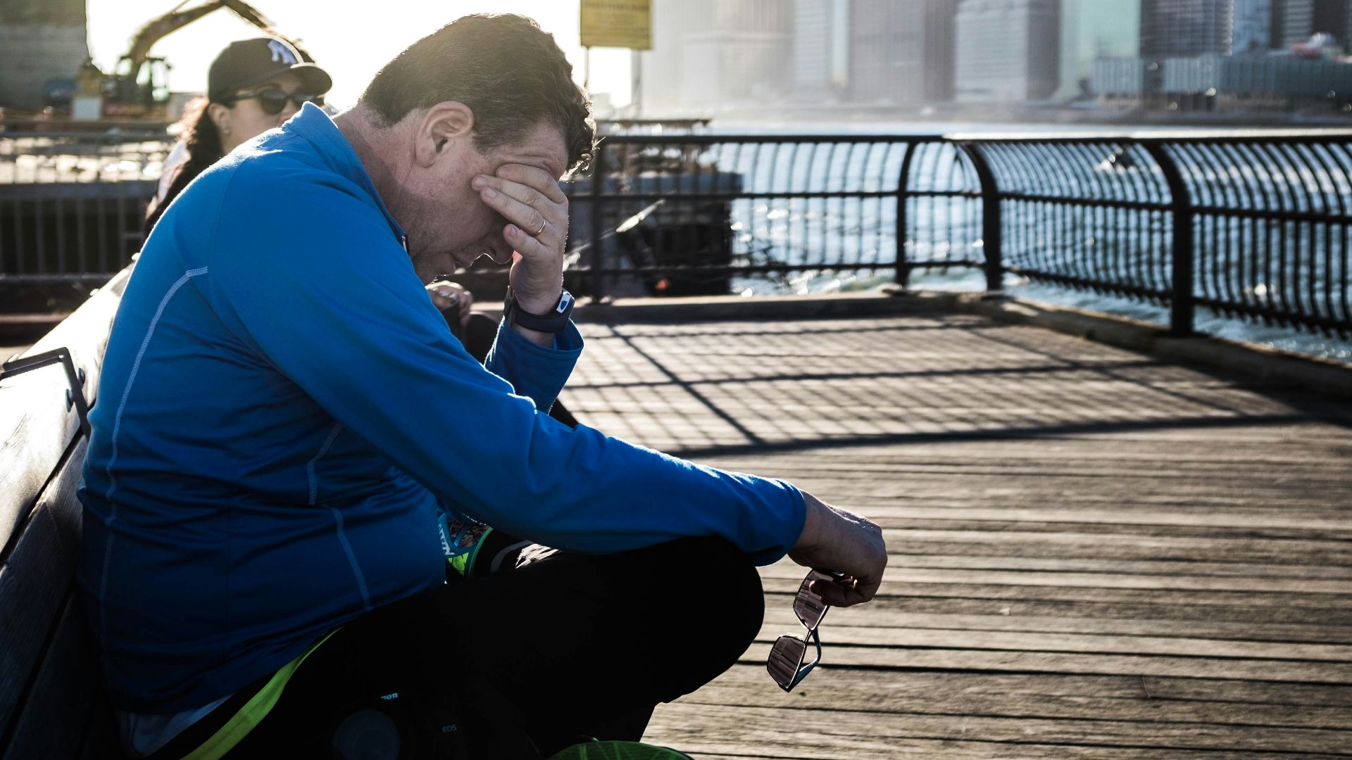 man sitting on bench beside woman
