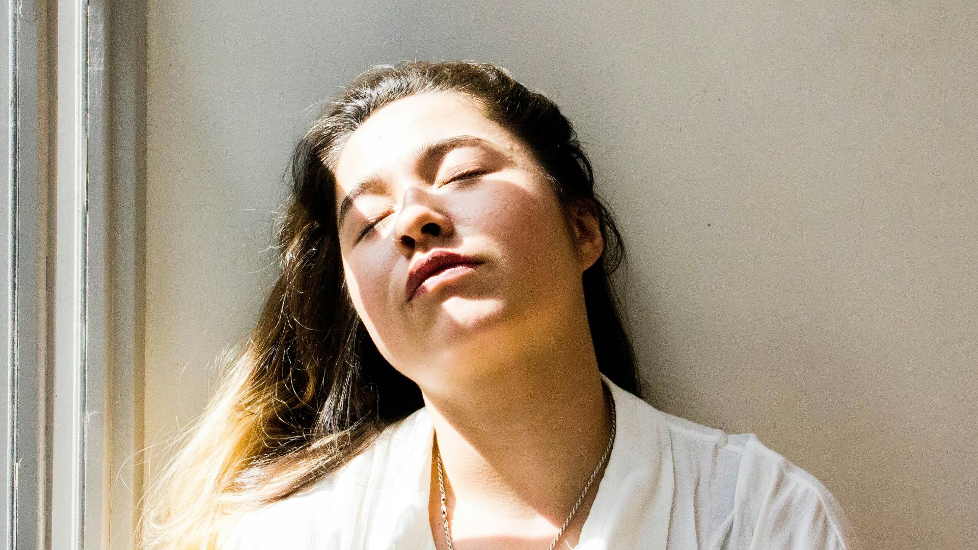 woman standing near window during daytime