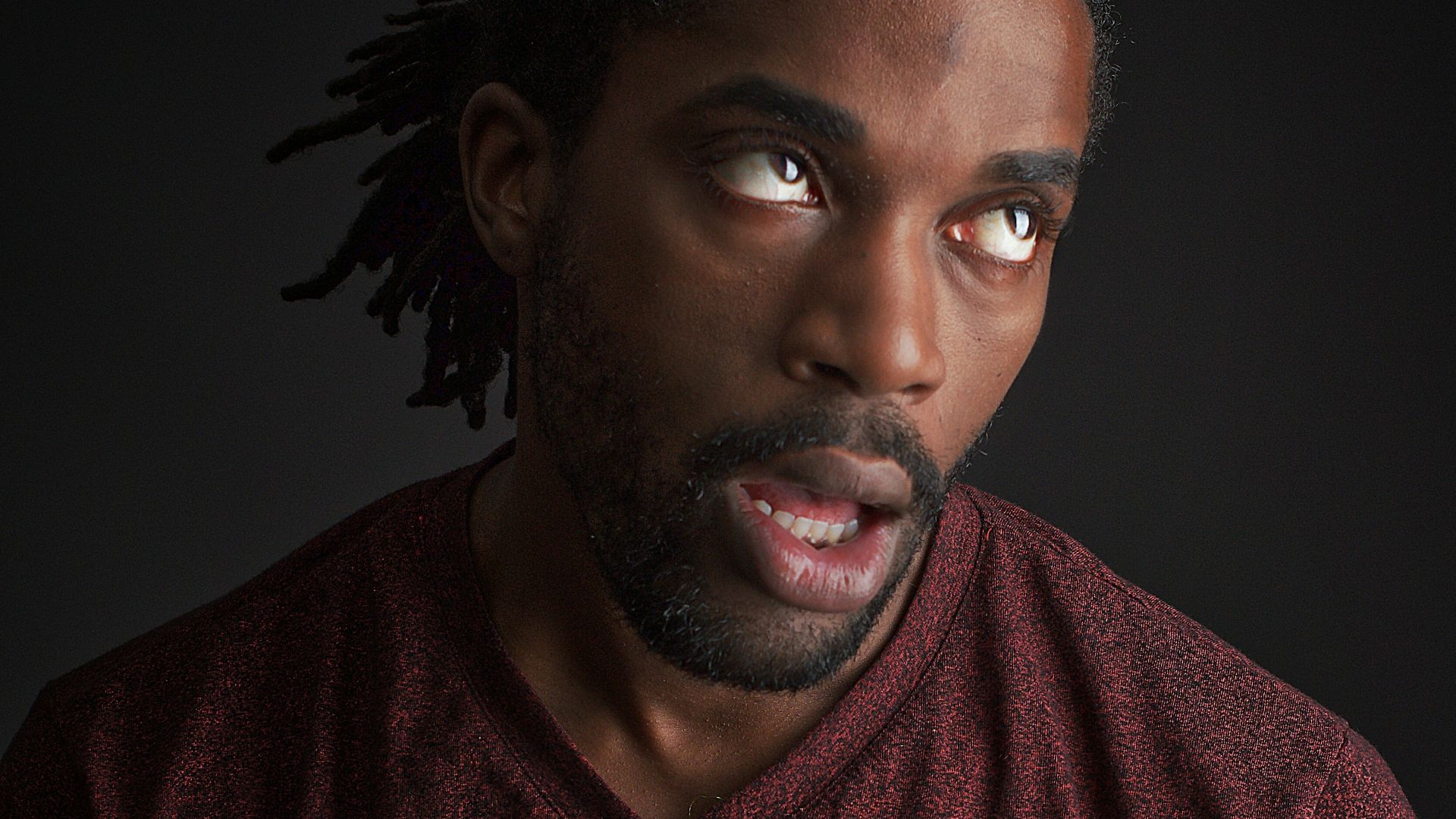 man opening his mouth and looking up