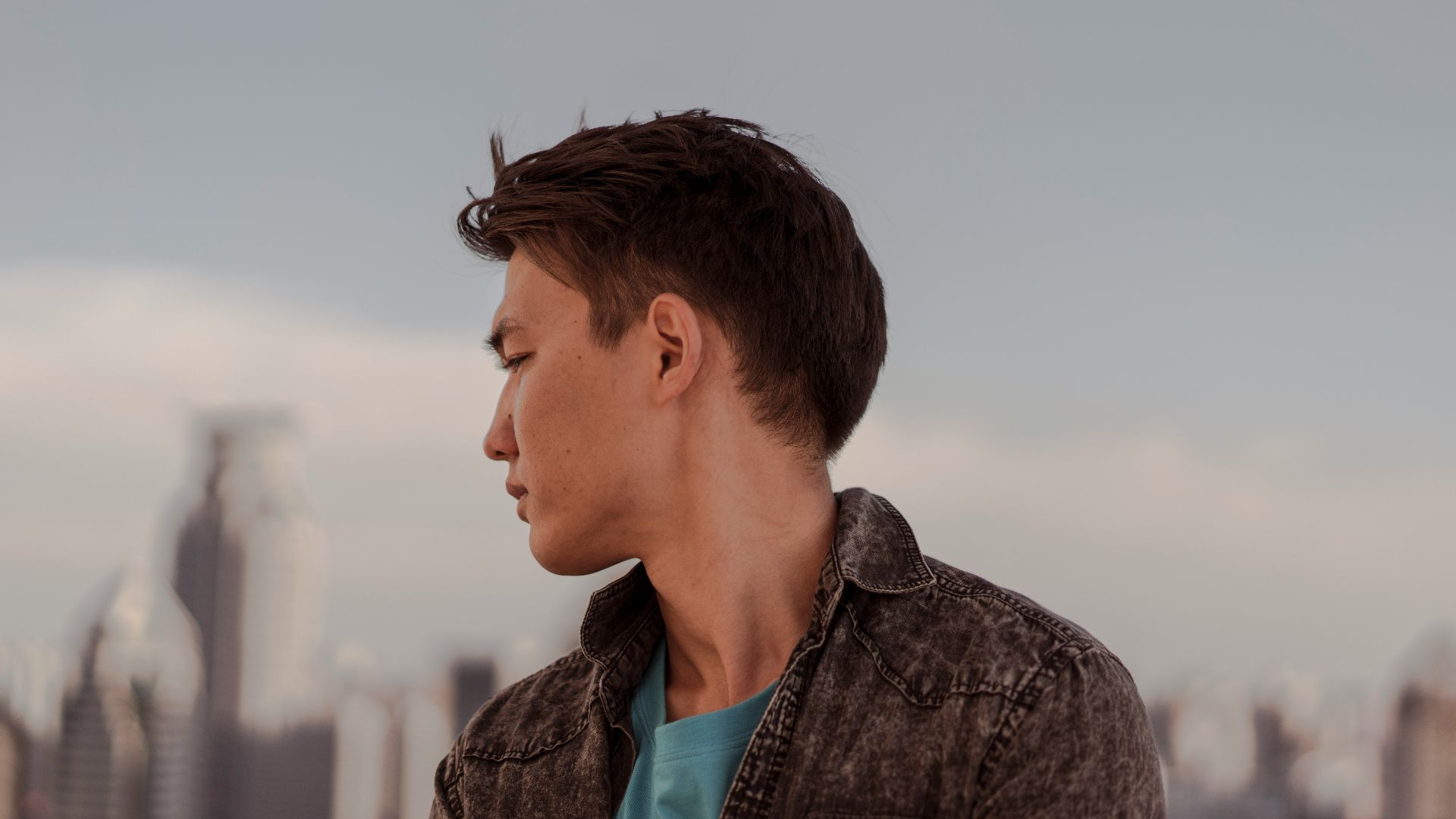 a man standing in front of a city skyline