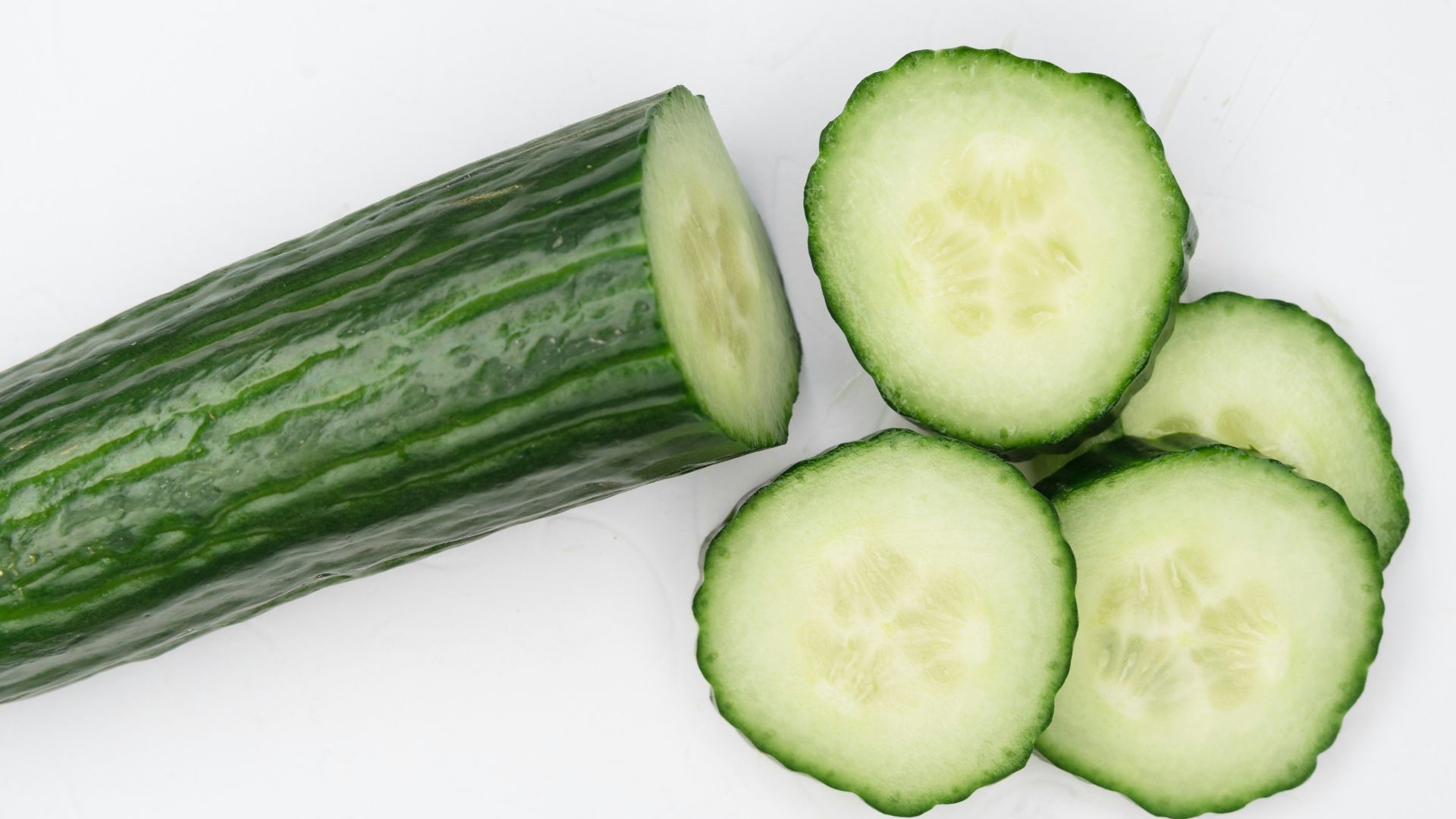 sliced cucumber on white surface