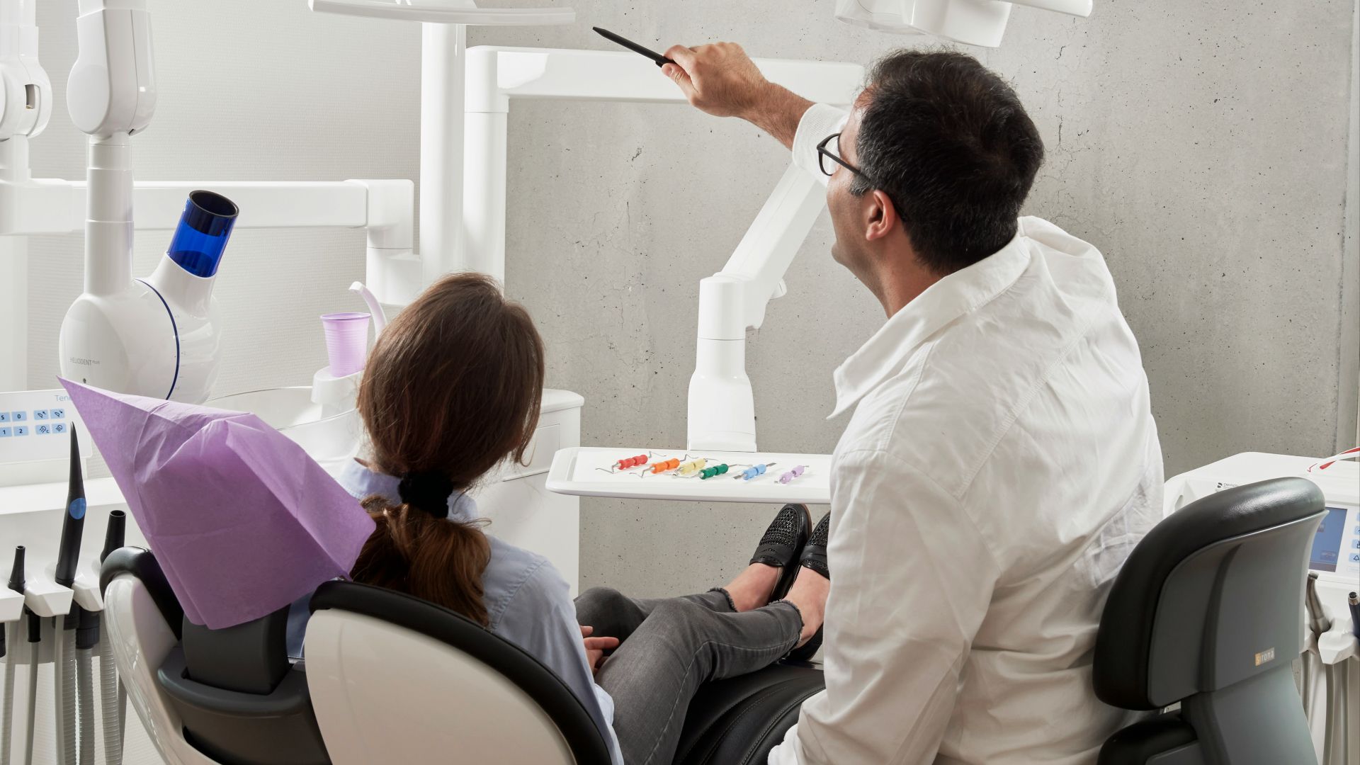 man in white dress shirt holding black pen