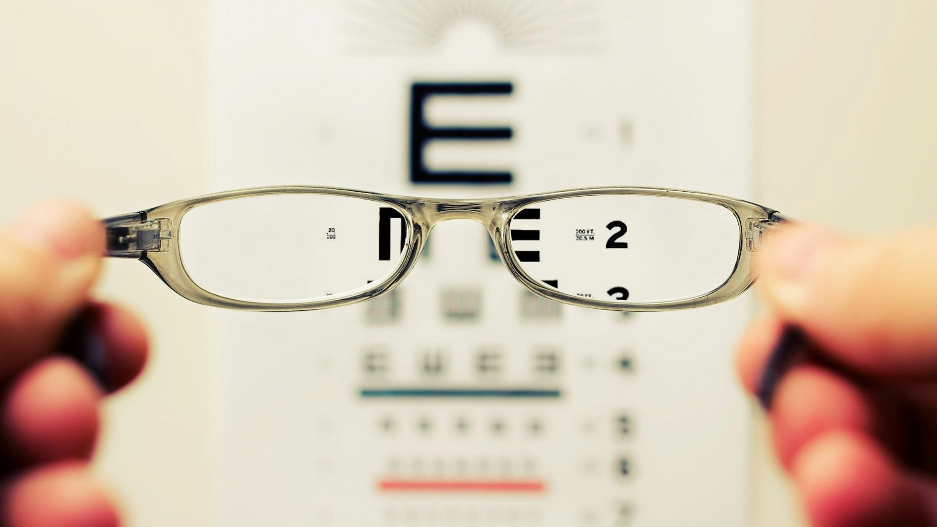 person holding eyeglasses