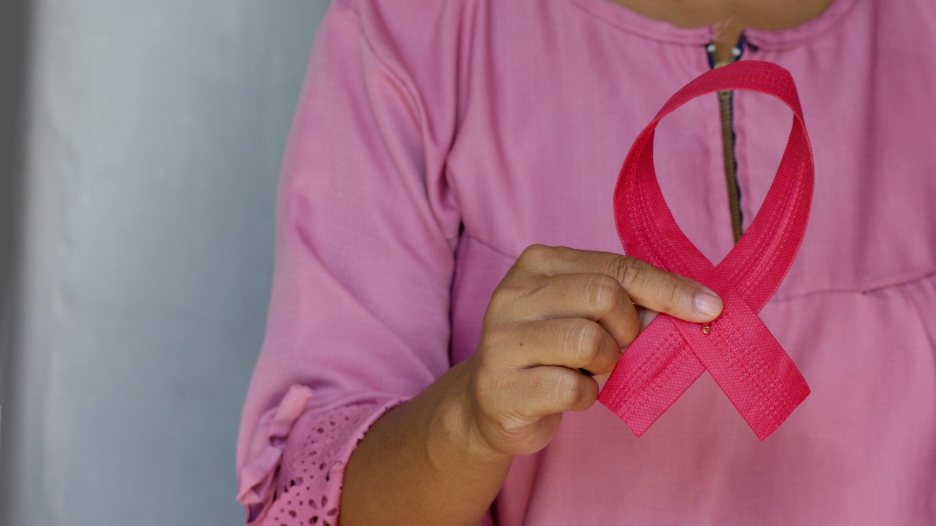 woman in pink and white polka dot shirt