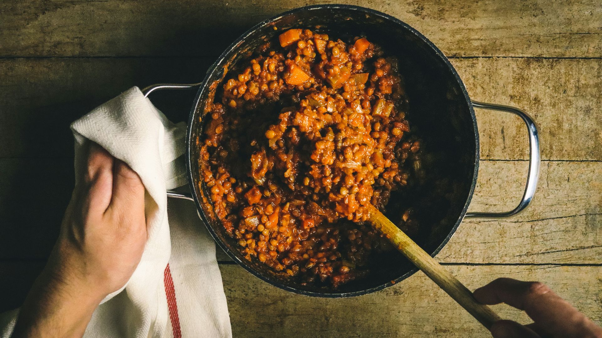 person holding stainless steel round tray with food