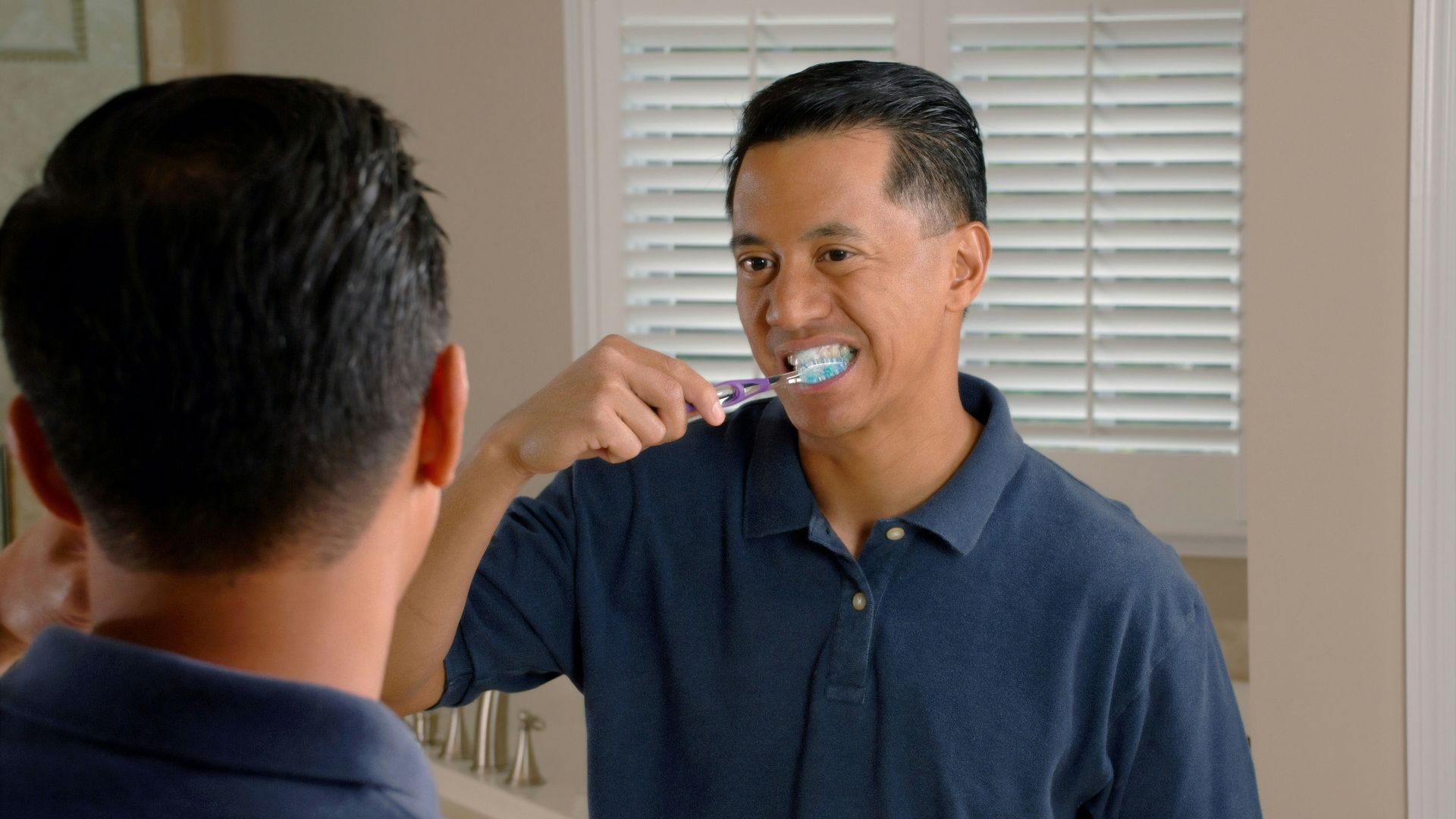 man in blue polo shirt smoking cigarette