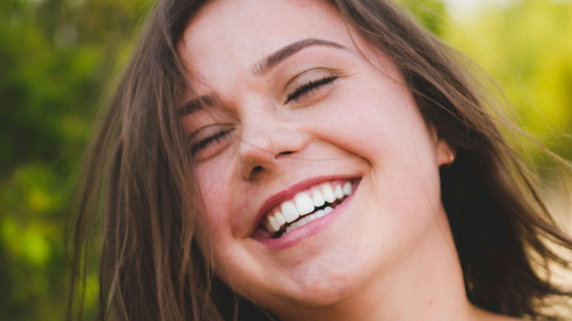 woman smiling wearing white top