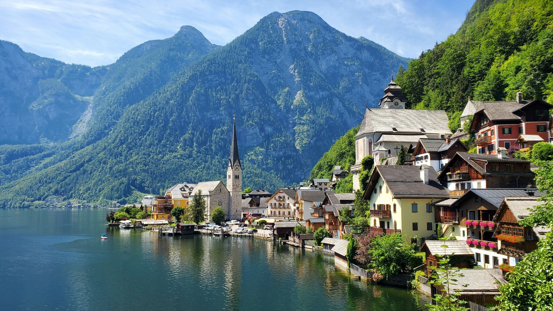 houses near body of water and mountain during daytime