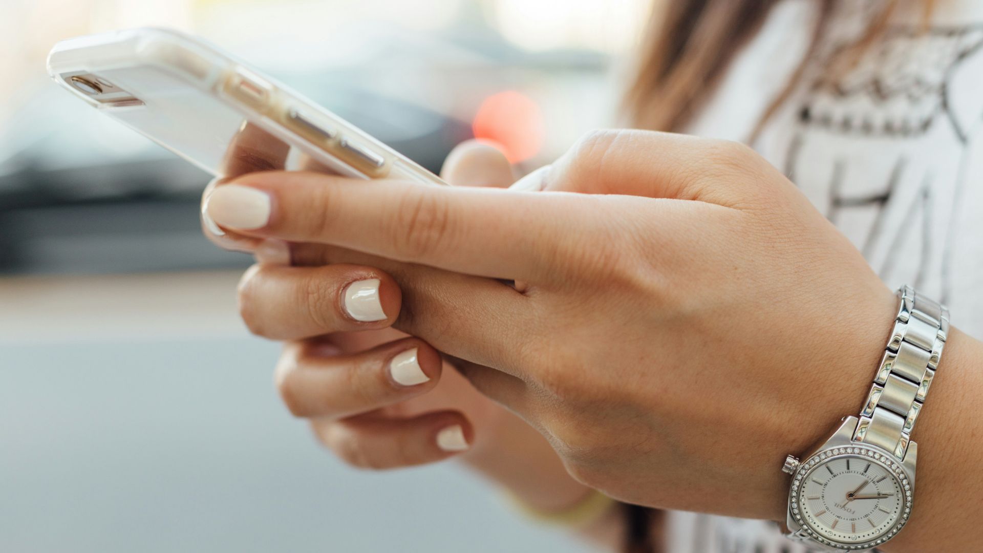 woman holding iPhone during daytime