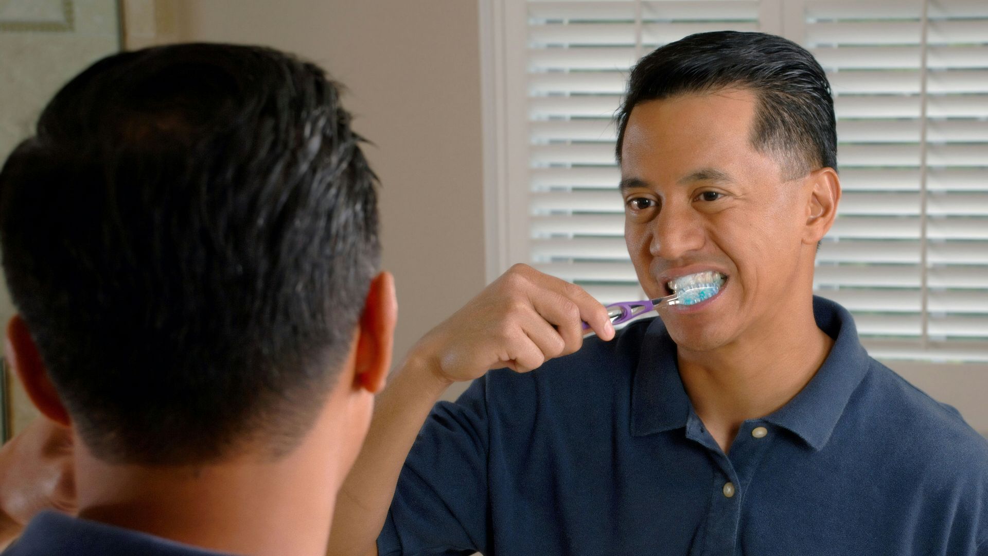 man in blue polo shirt smoking cigarette
