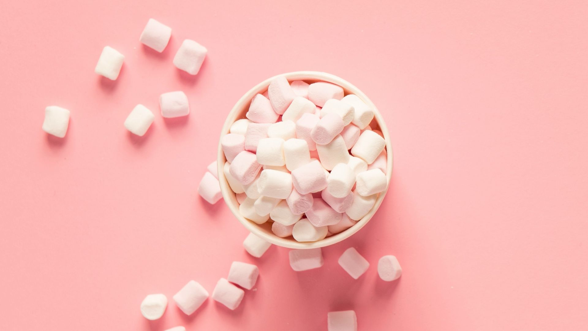 bunch of marshmallows on pink surface