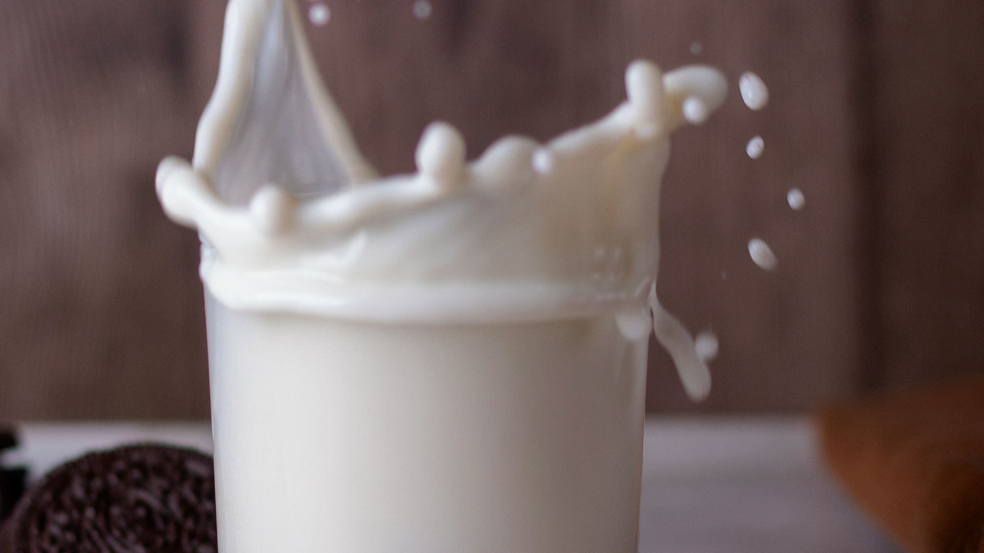 a glass with a spoon in it and a cup with a substance in it