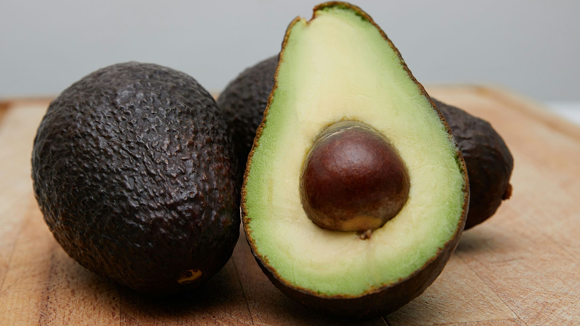 sliced avocado fruit on brown wooden table