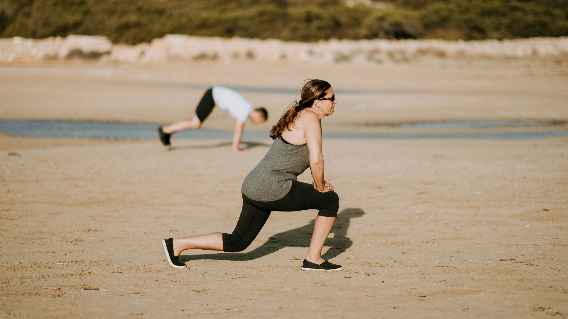 woman wearing grey tank top doing exercise