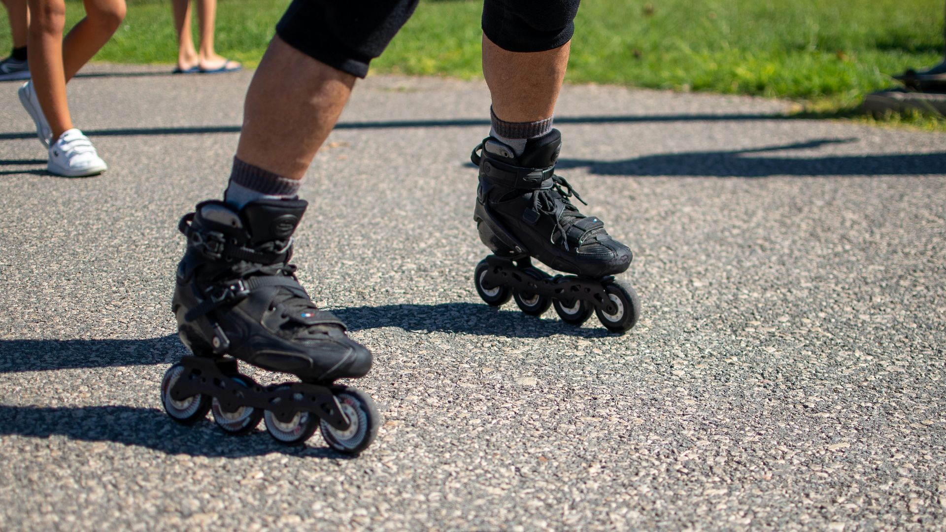 a group of people riding roller skates down a street