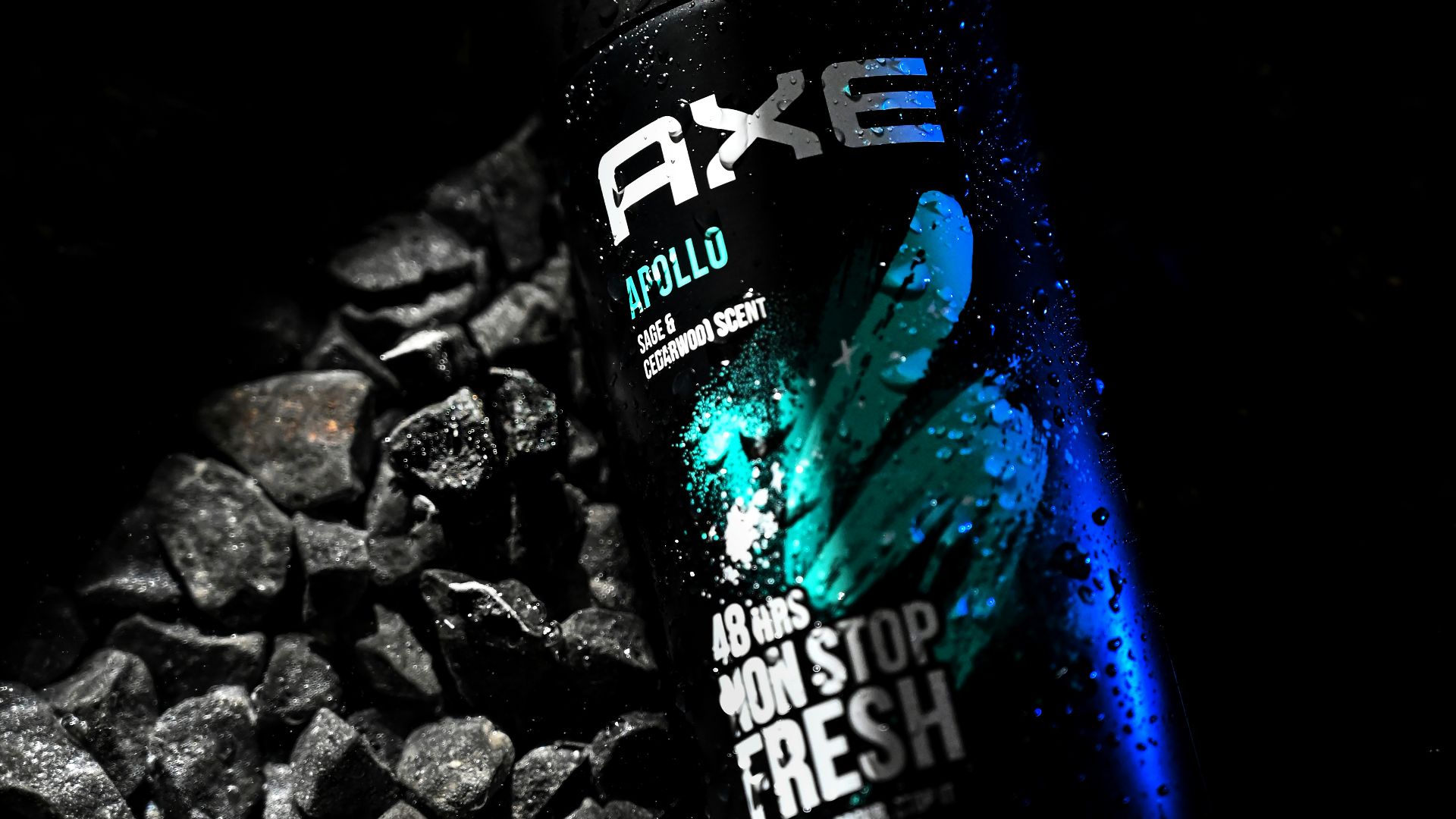 a close up of a bottle of water on a bed of rocks