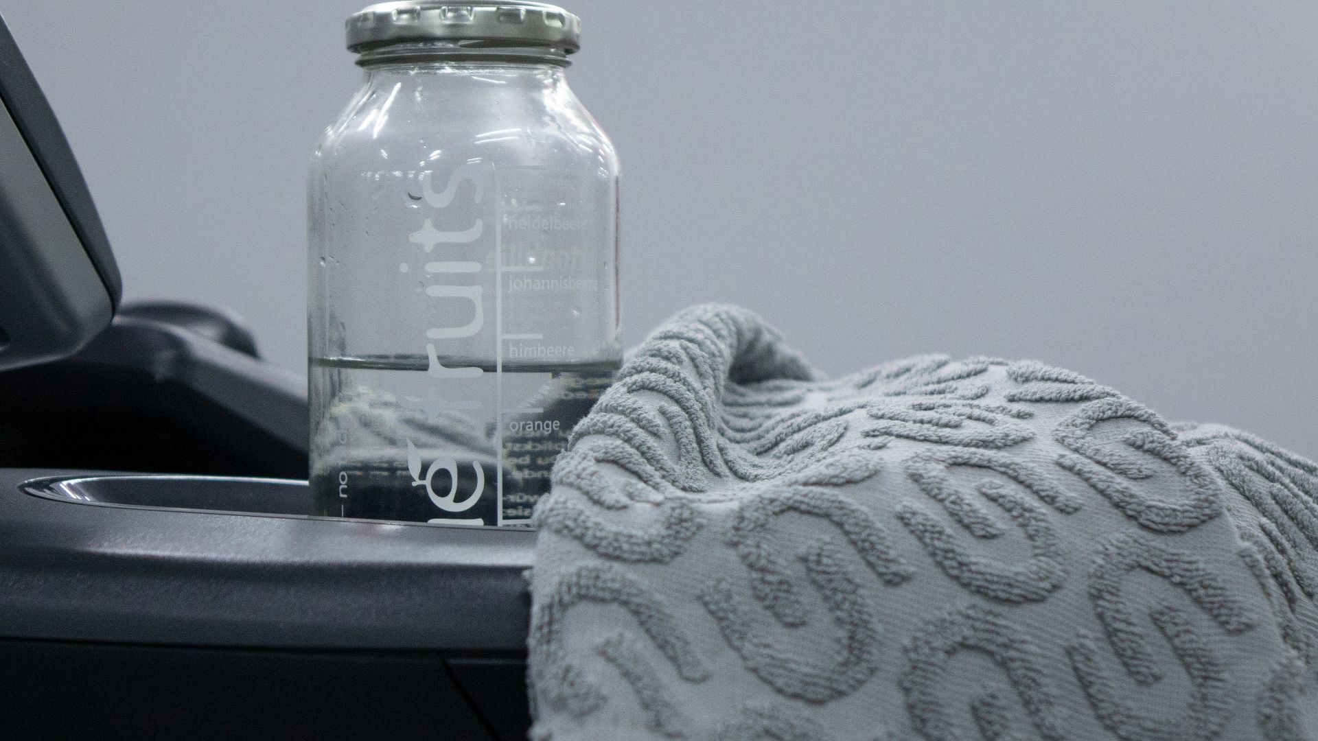 a bottle of water sitting next to a towel