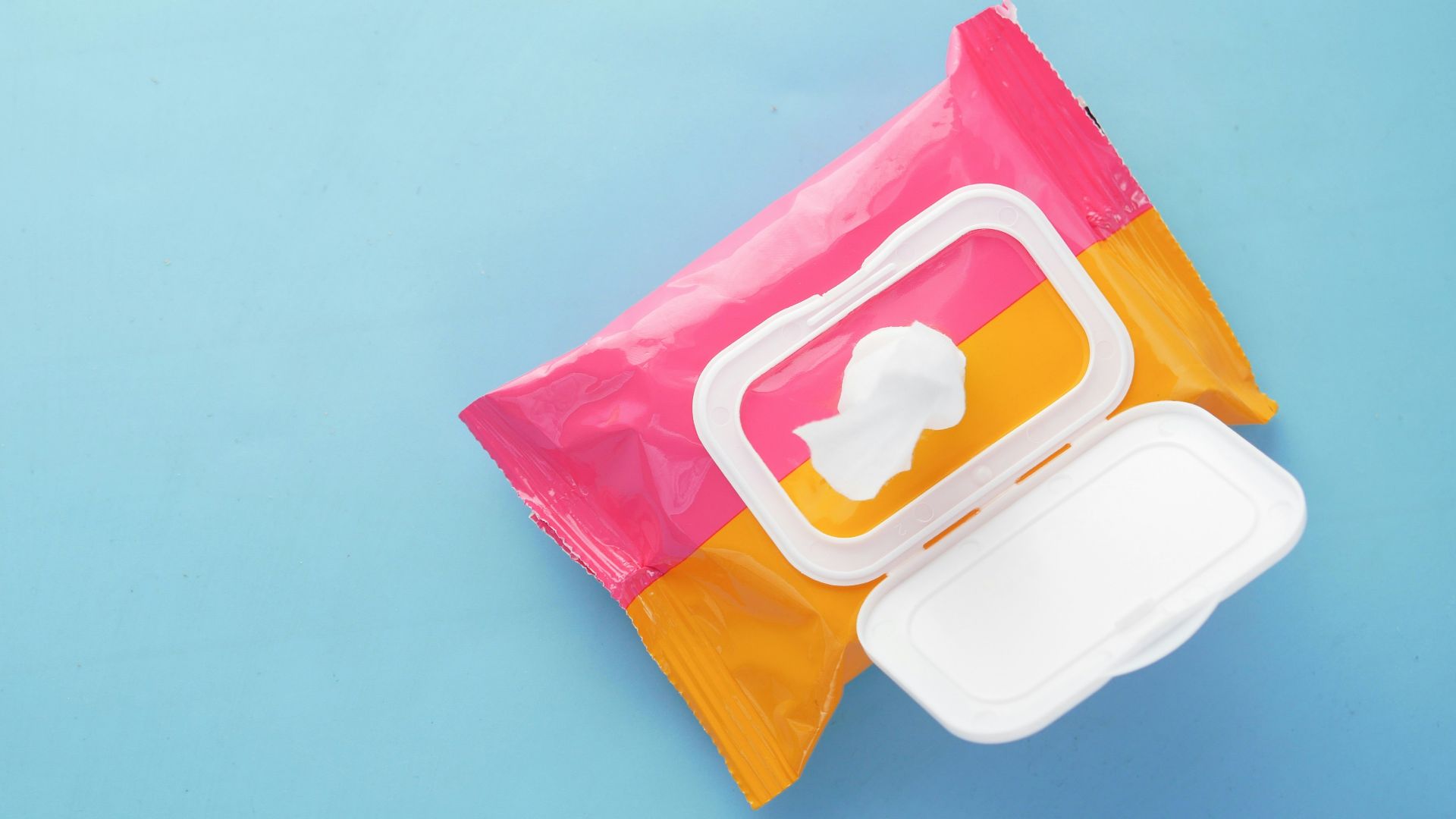 a pink and yellow bag of food on a blue surface