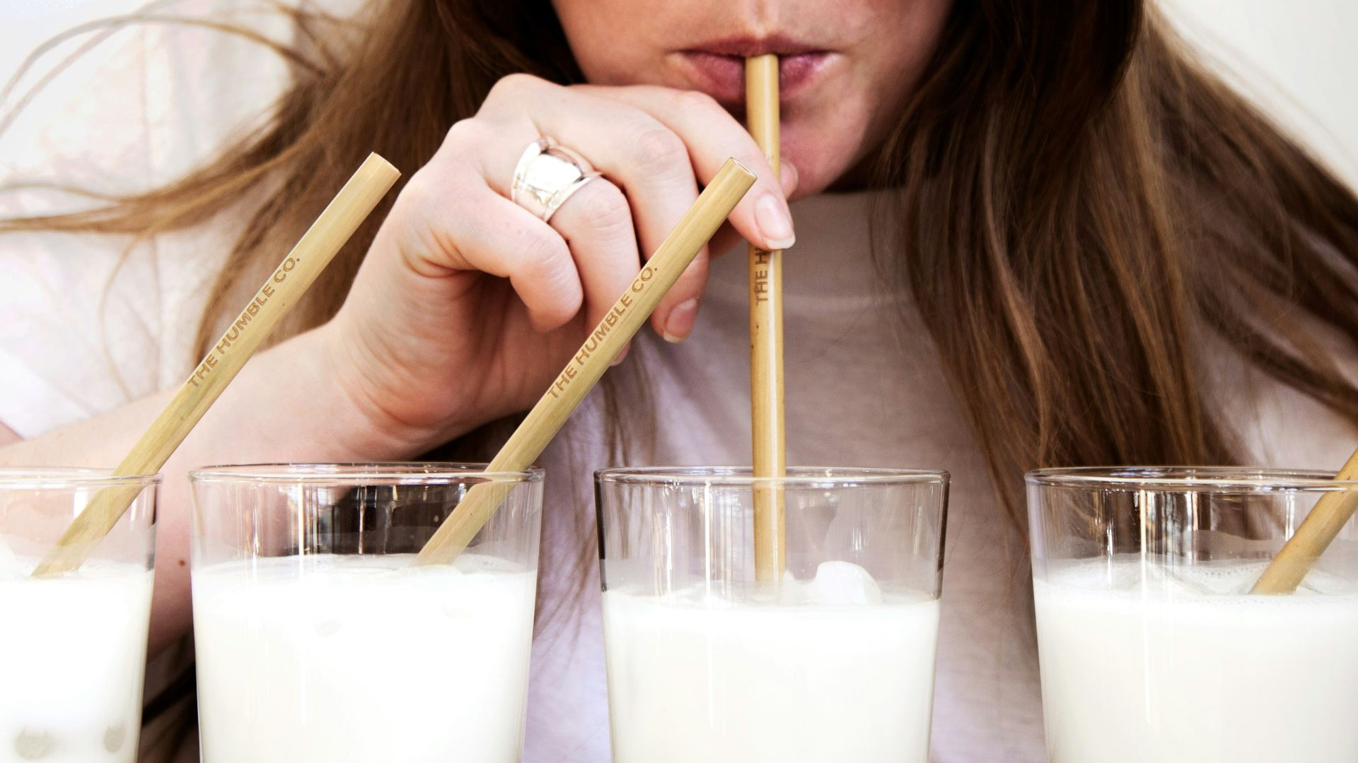 woman holding brown wooden chopsticks