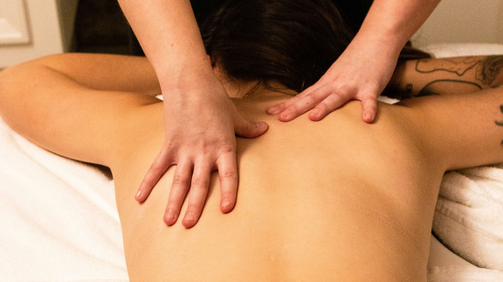 a woman getting a back massage at a spa