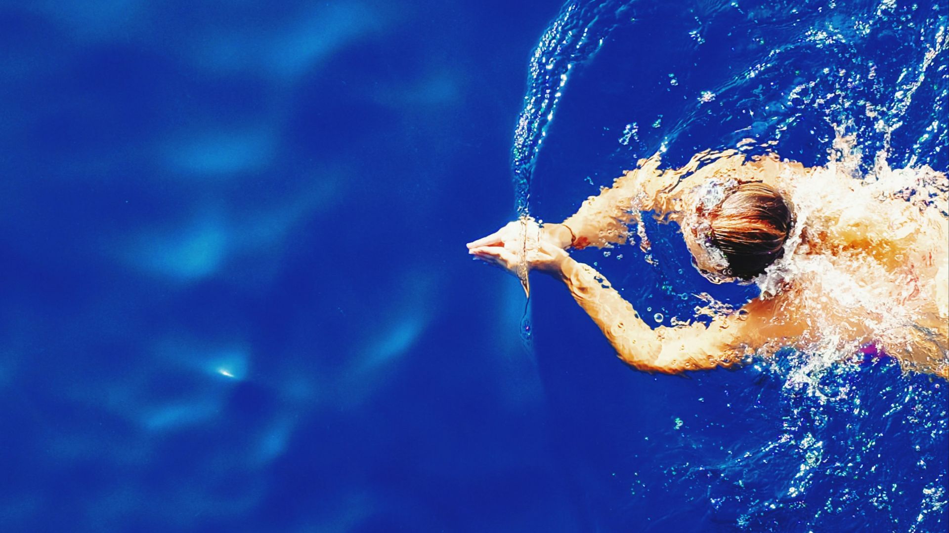 close-up photography of woman swimming on calm water