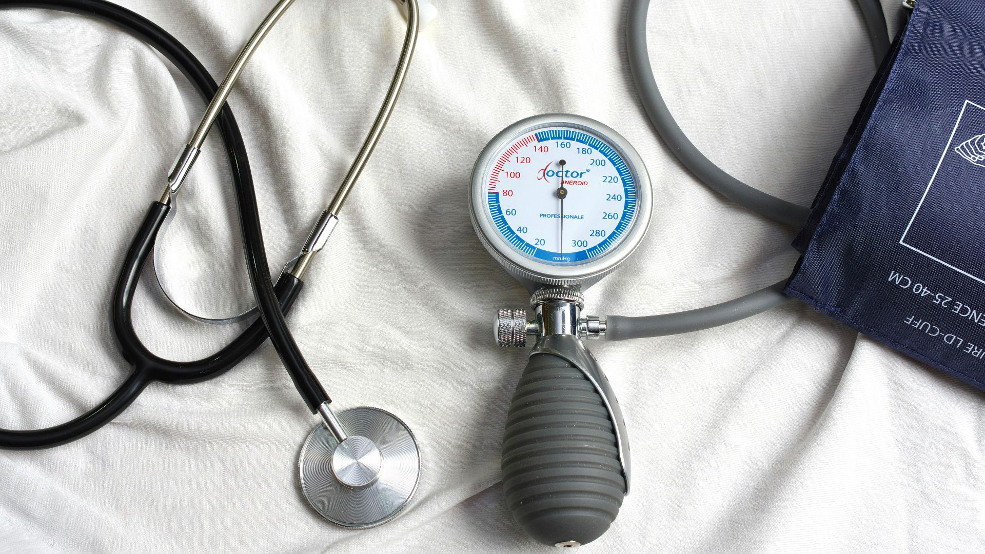 a stethoscope laying on top of a bed next to a medical bag