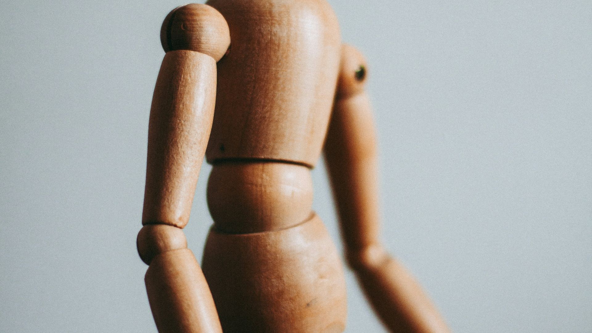 colse-up photo of brown wooden doll