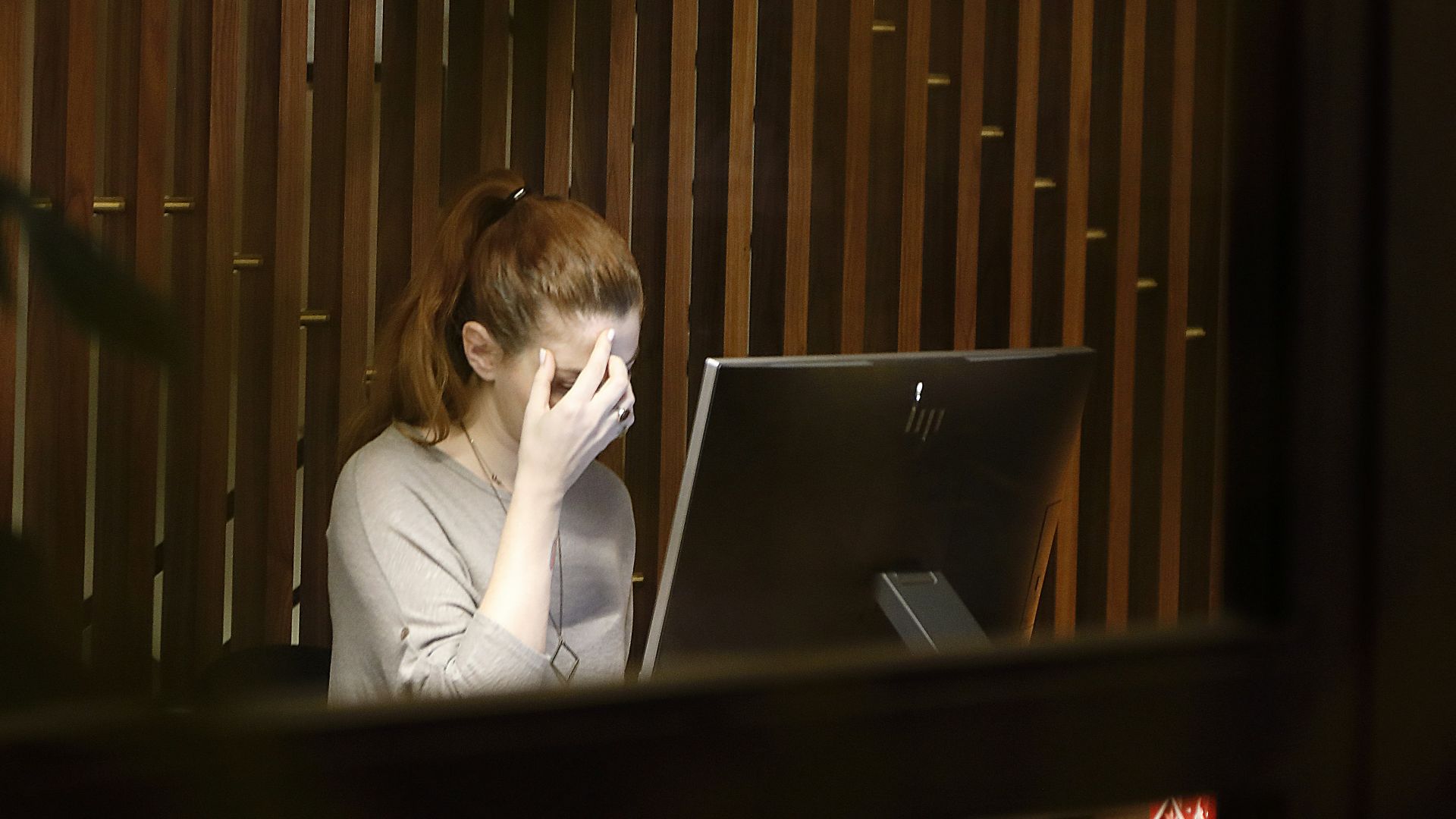 a woman sitting in front of a laptop computer