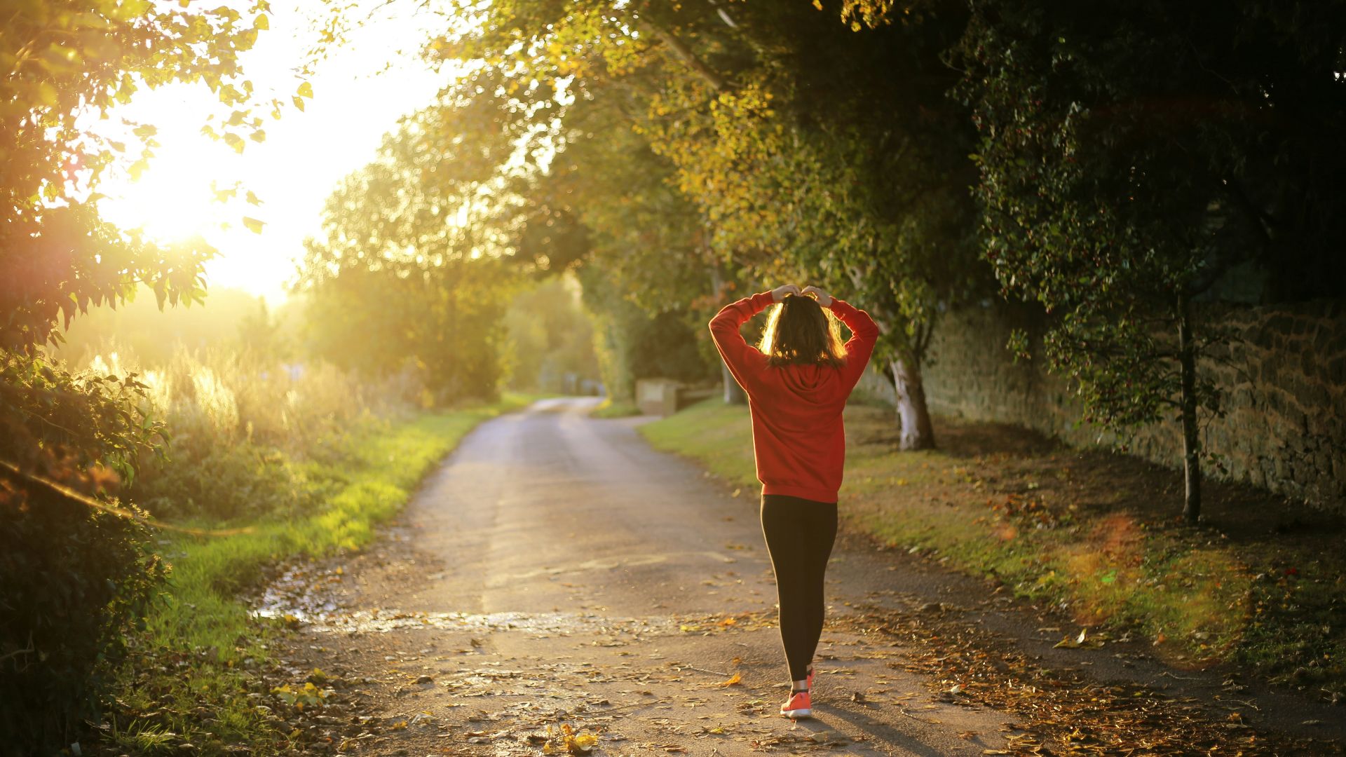 woman walking on pathway during daytime