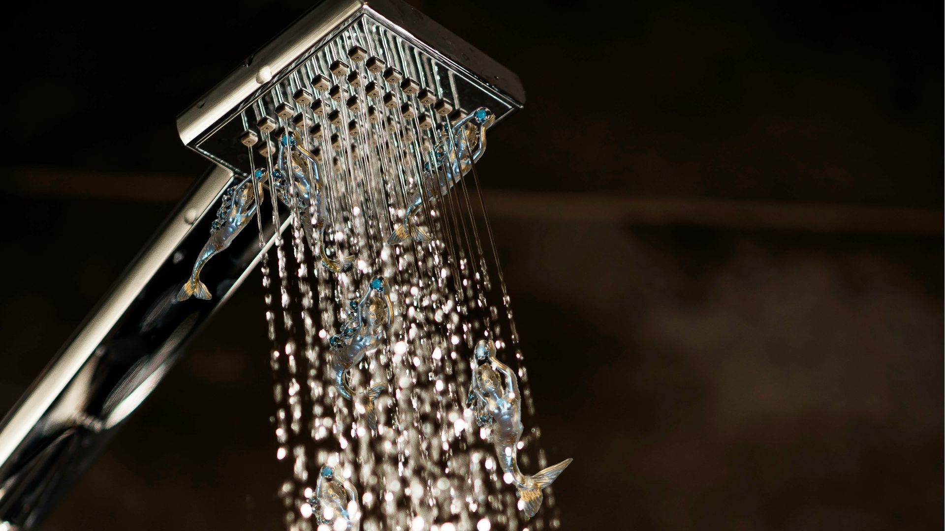 a close up of a shower head with water coming out of it