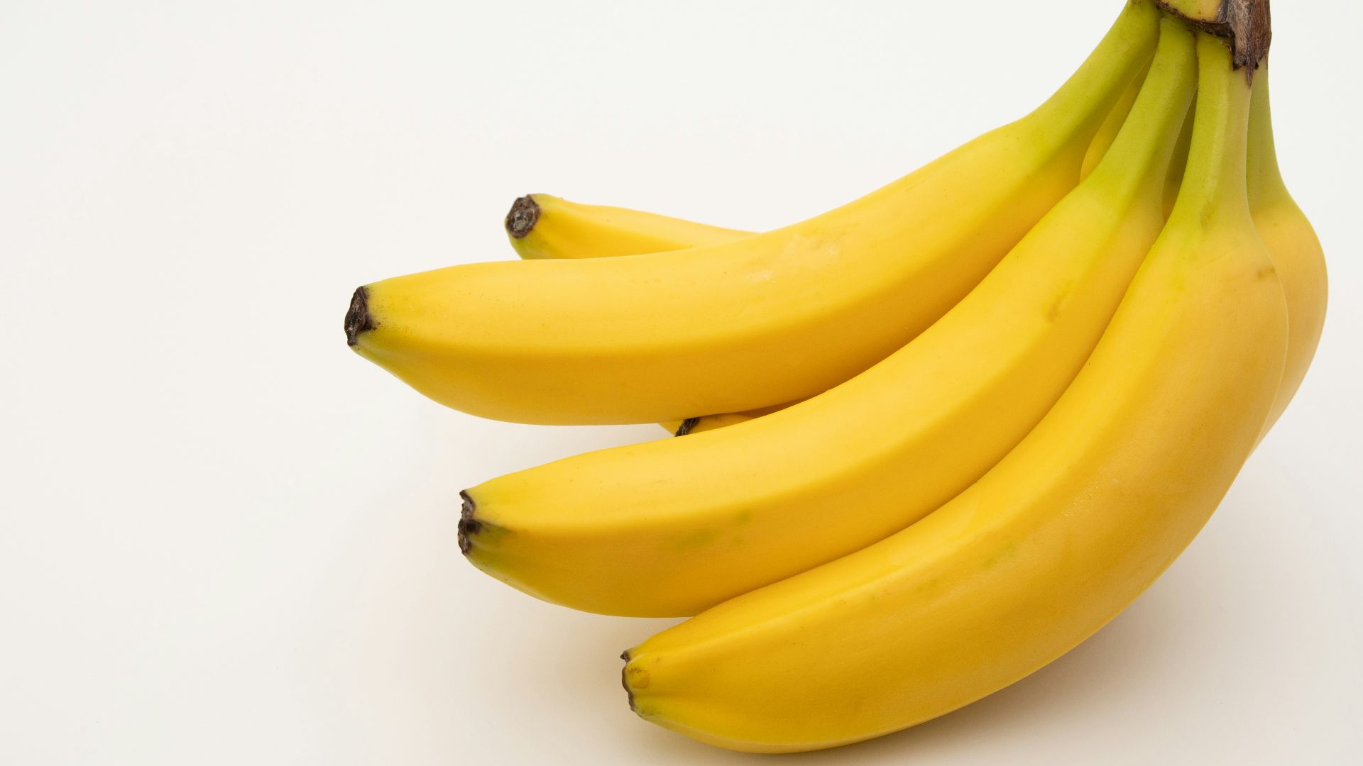 a bunch of bananas sitting on top of a white table