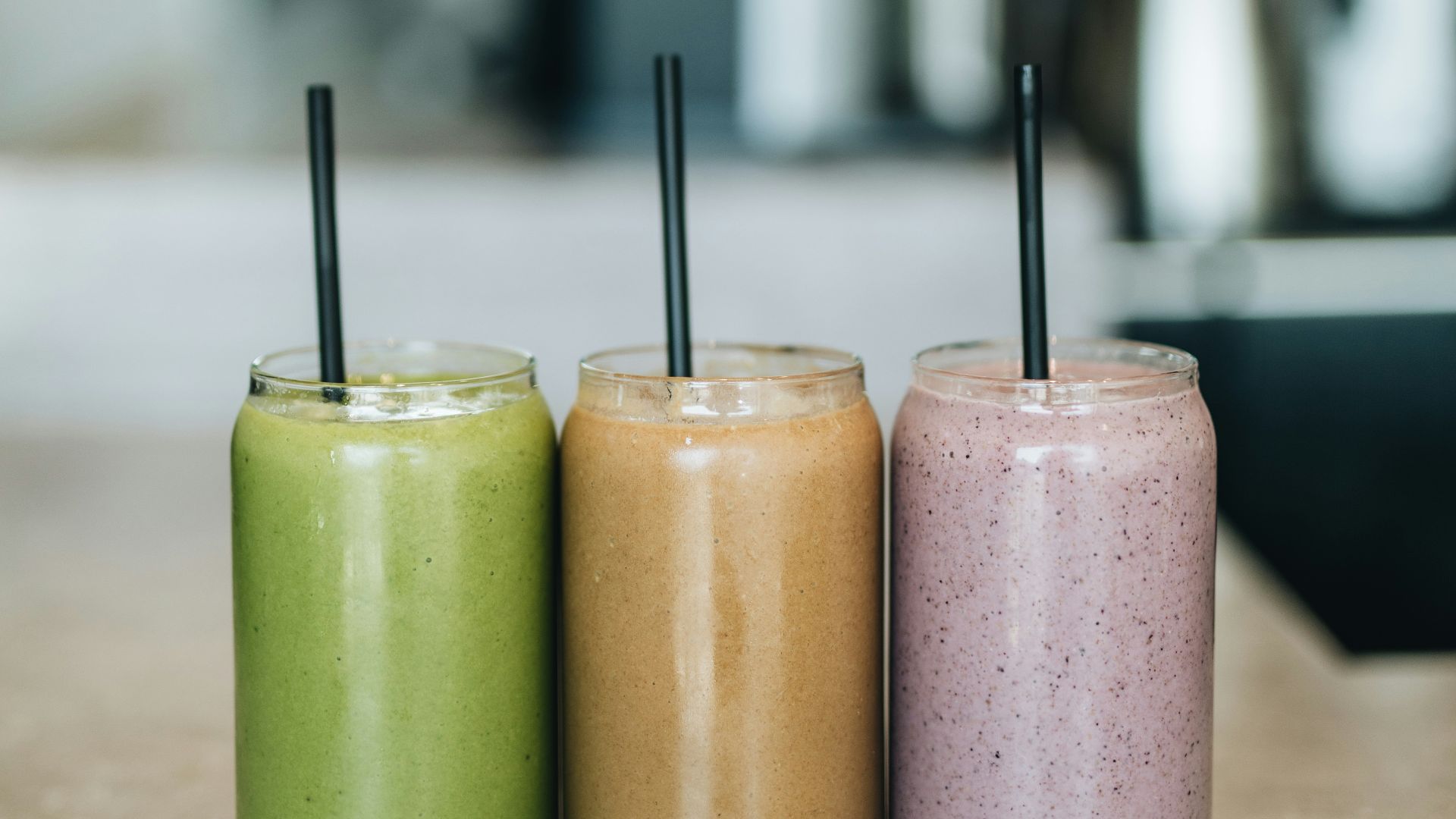 three drinks on gray surface
