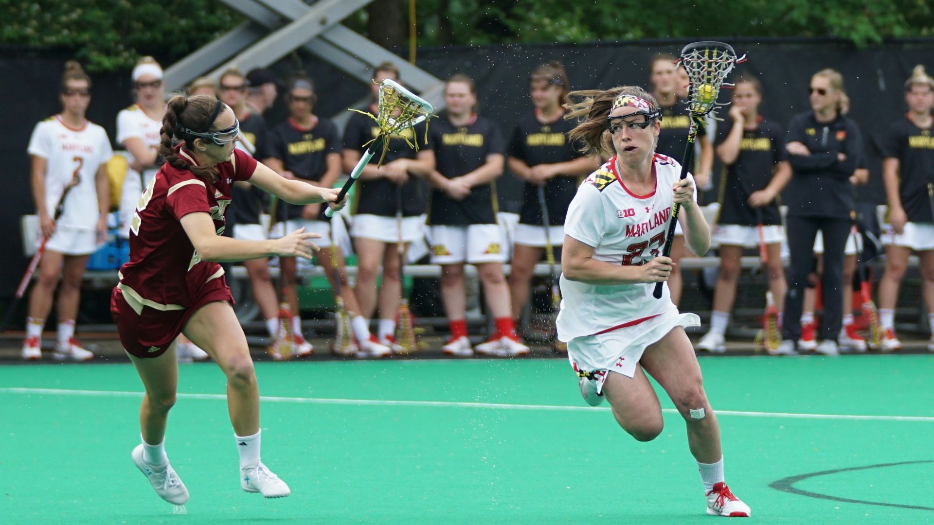 women playing lacrosse game during daytime