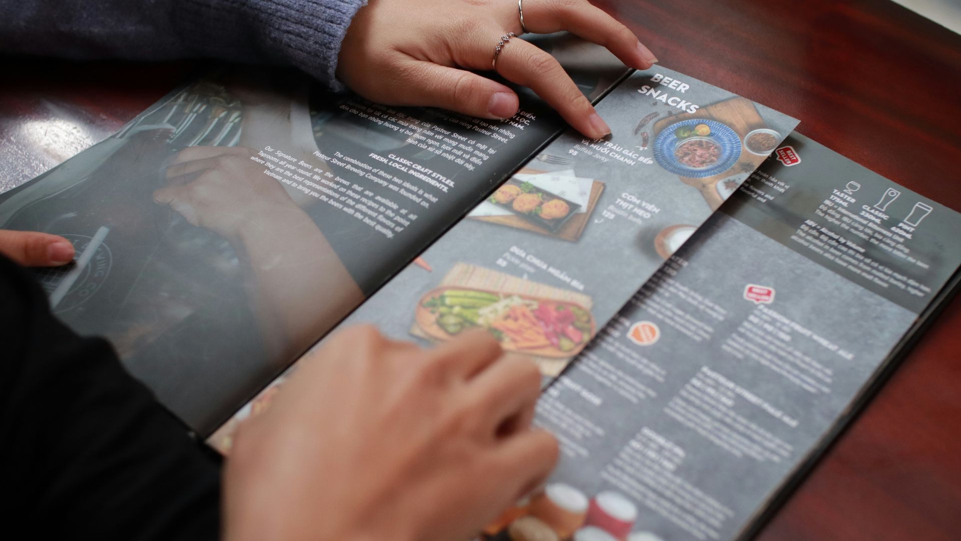 person holding white and black labeled box