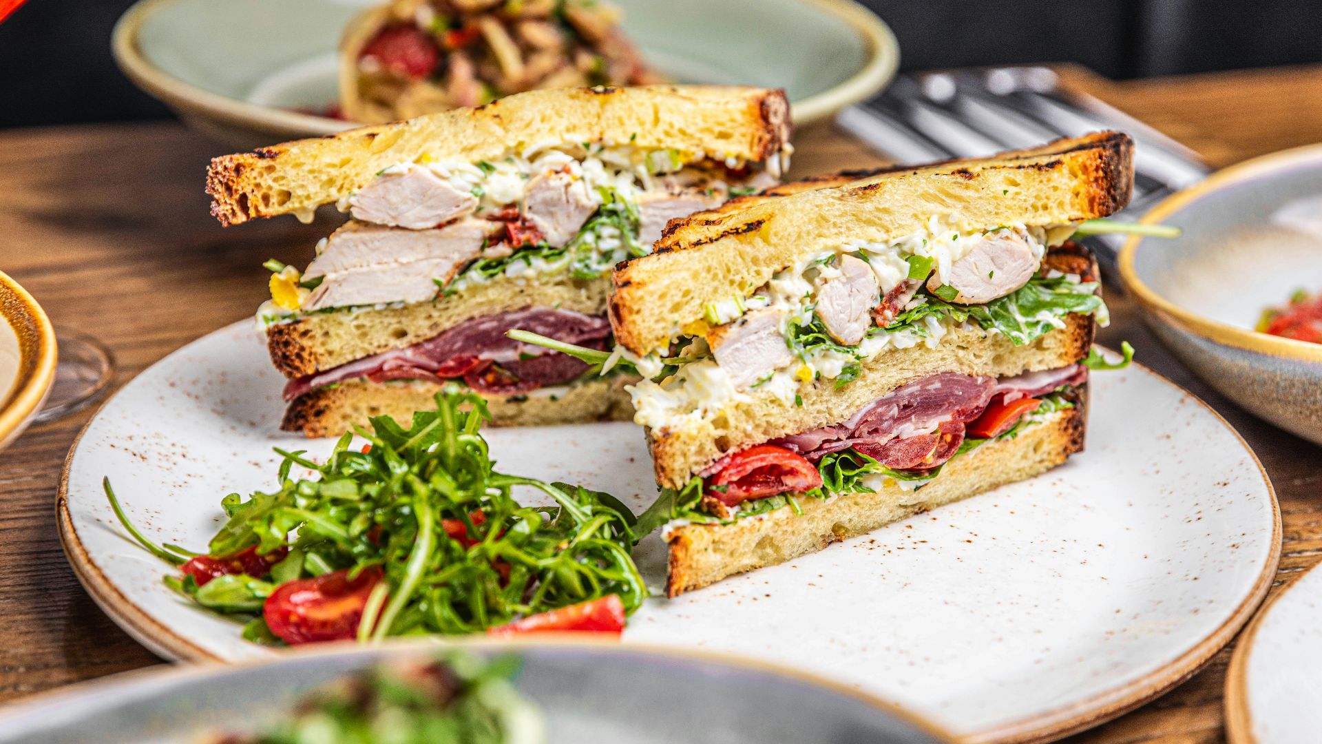 a cut in half sandwich sitting on top of a white plate