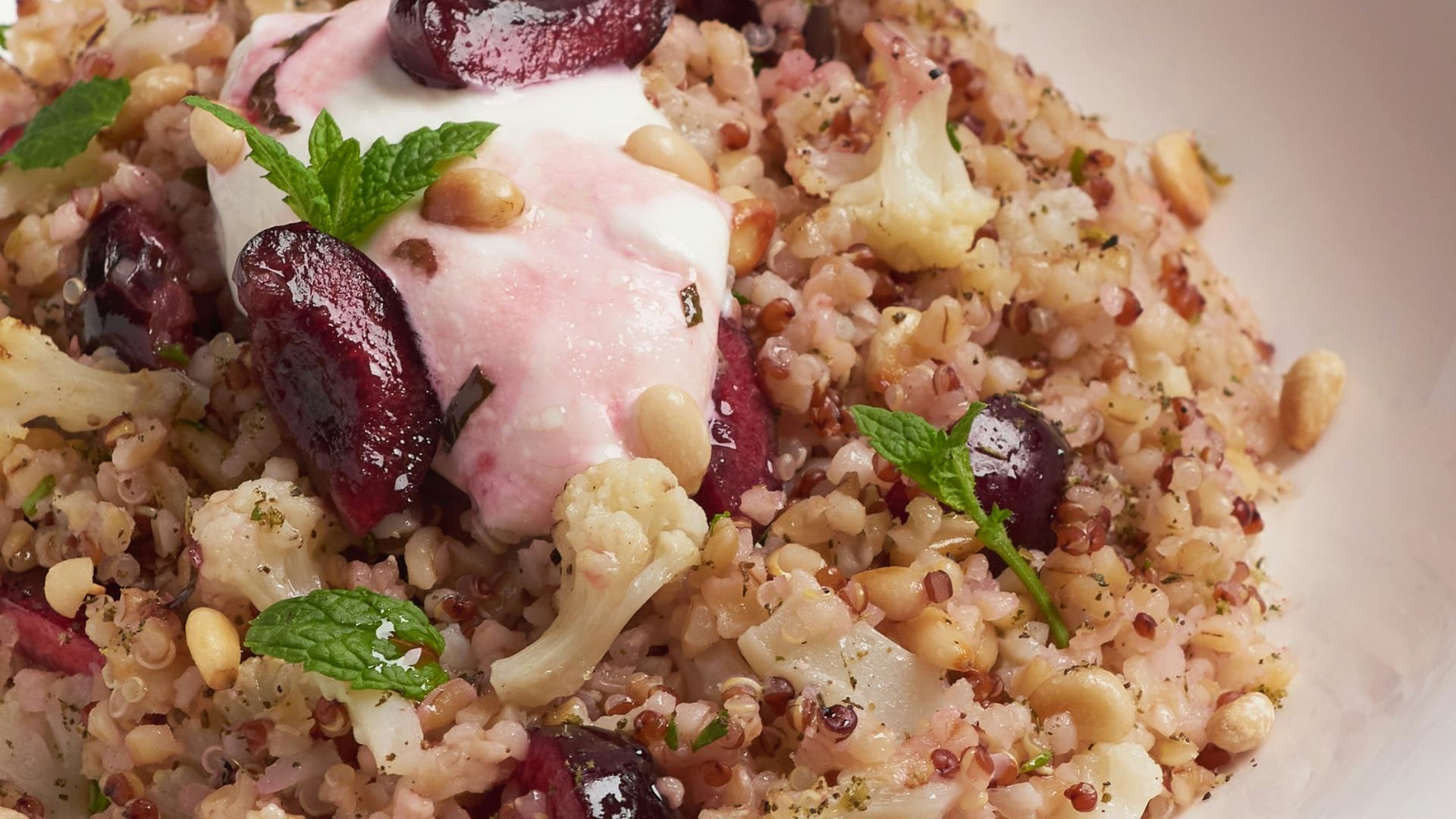a white bowl filled with food on top of a table