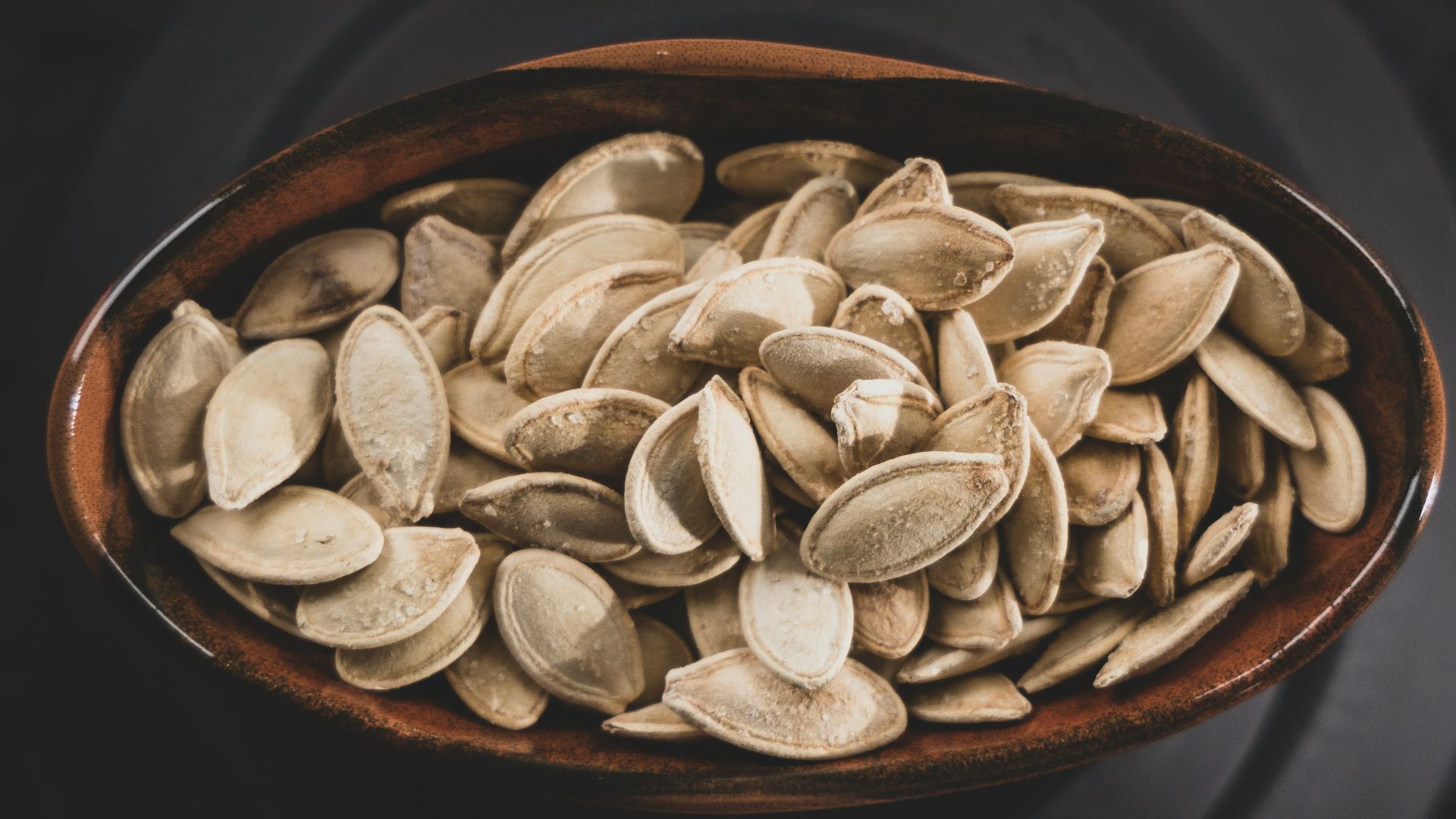 brown and white nuts on brown ceramic bowl