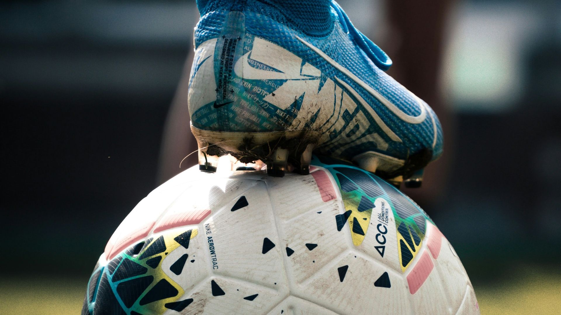 white and blue soccer ball on green grass field